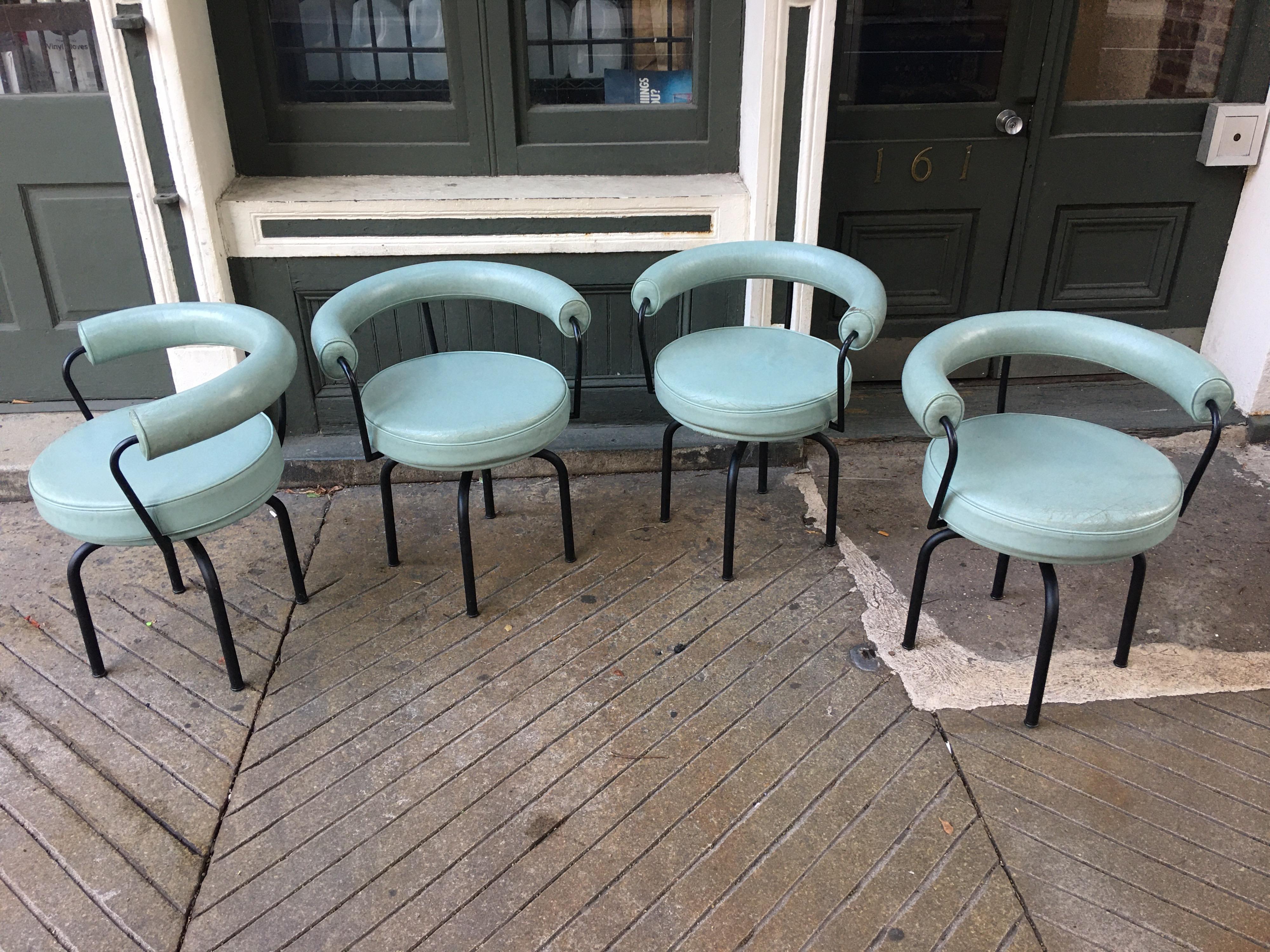 Set of 4 Cassina Swivel LC7 armchairs in a Robin egg blue leather. Frames are done in a flat black finish which is all original. Chairs date from the early 1990s. Originally designed in the late 1920s by Le Corbusier, Perriand and Jenneret.