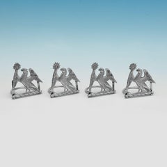 Set of 4 cast sterling silver menu holders modelled as crests made in 1891