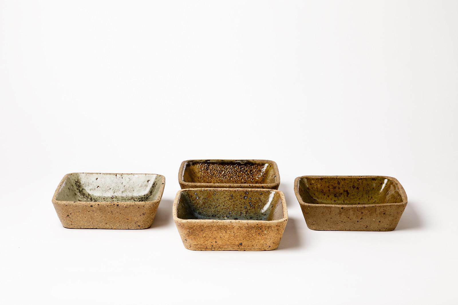 Pierre Digan 

Elegant stoneware ceramic set of 4 bowls or dishes by the French artist.

4 differents ceramic glazes colors, brown, green, blue and grey.

Original set realized circa 1975 in La Borne, mid-20th century design.

Original