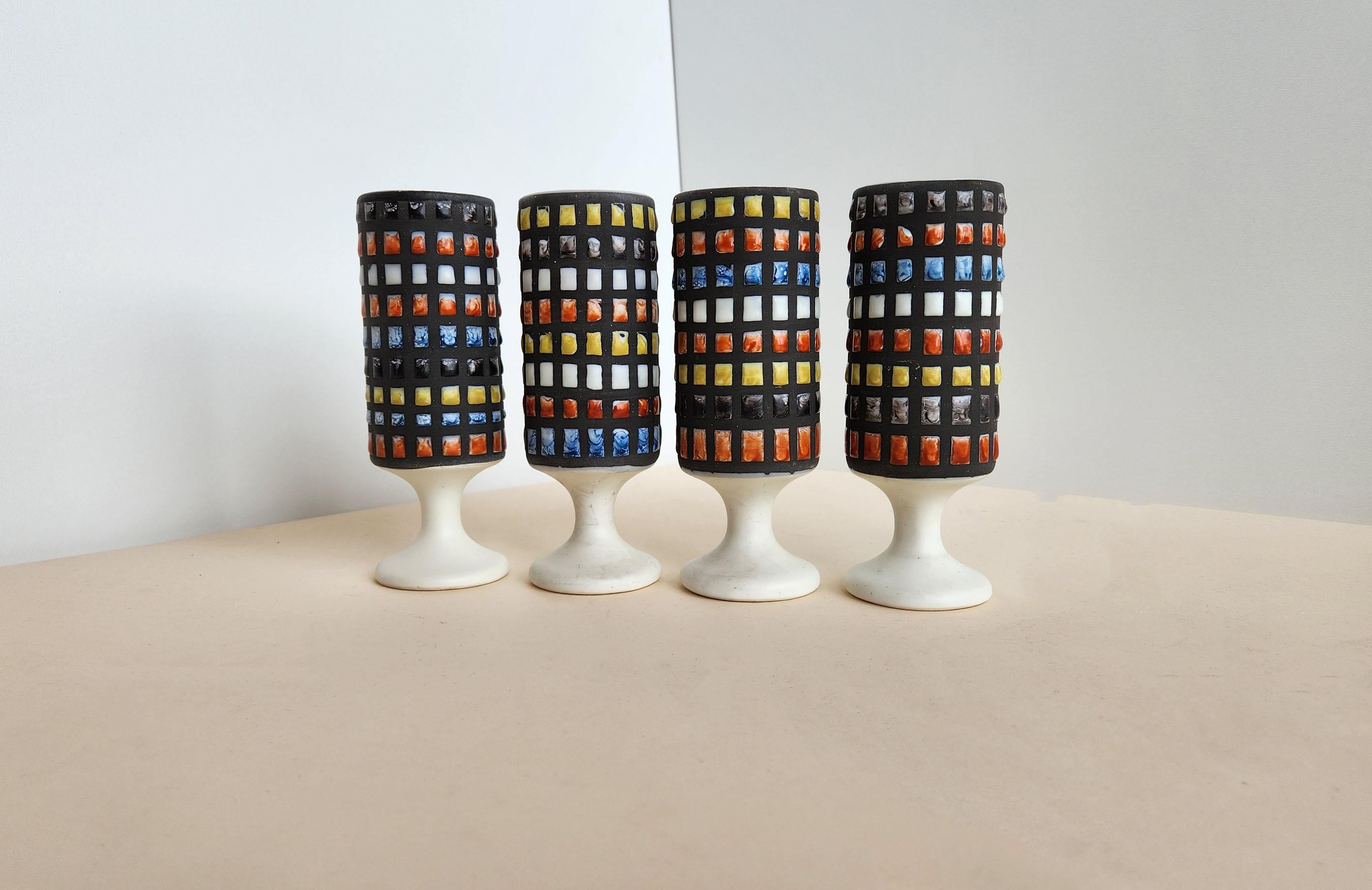 Set of 4 cups with cobblestones Signed by Roger Capron.

Vallauris, France.

Roger Capron was in influential French ceramicist, known for his tiled tables and his use of recurring motifs such as stylized branches and geometrical suns. He was born in