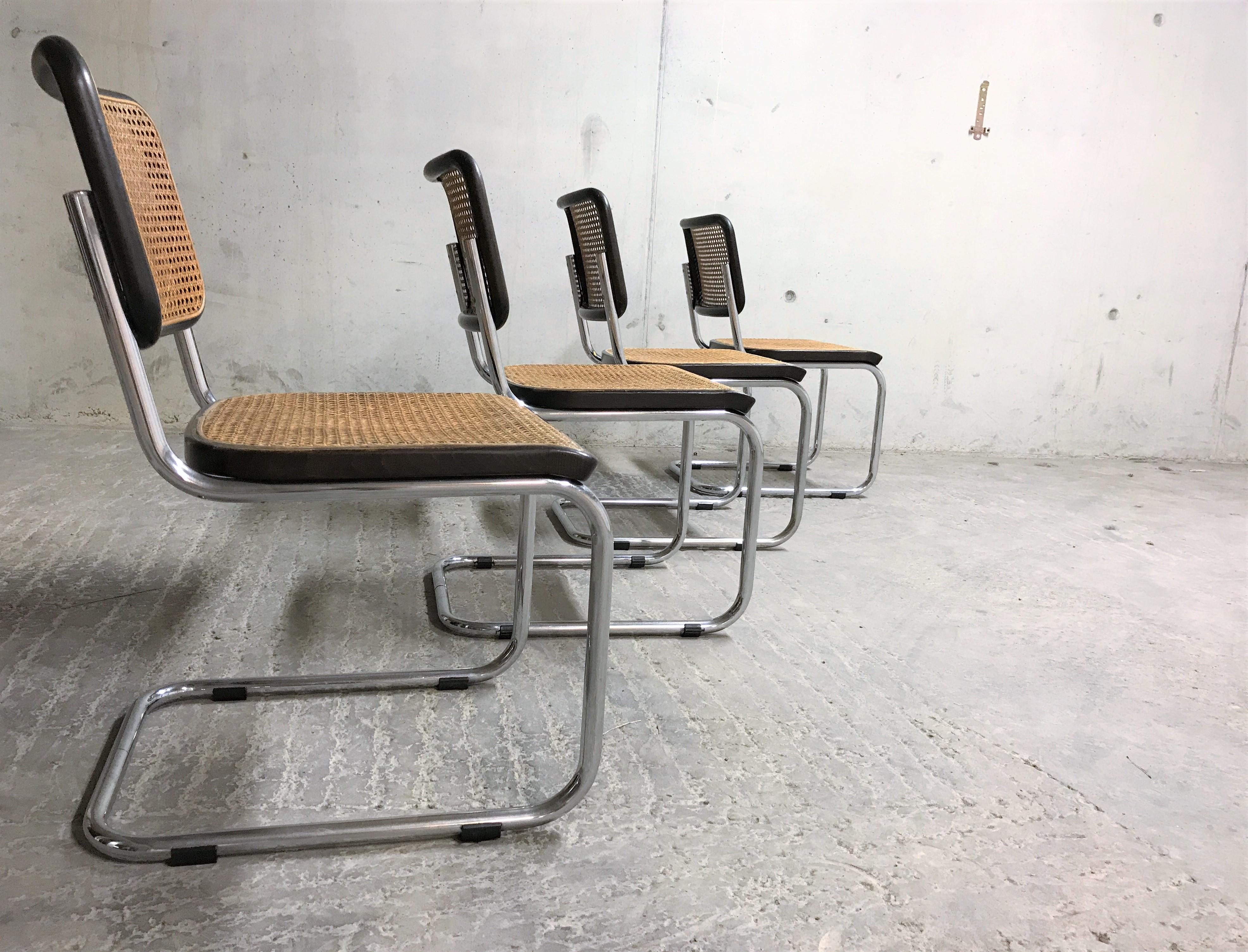 Set of 4 Marcel Breuer Bauhaus design chairs model B32. Original design dates from 1926.

Tubular chrome frame, cane seats and black lacquered wood.

Very good condition.

One of the chairs has some wear on the top of the backrest.

Stamped