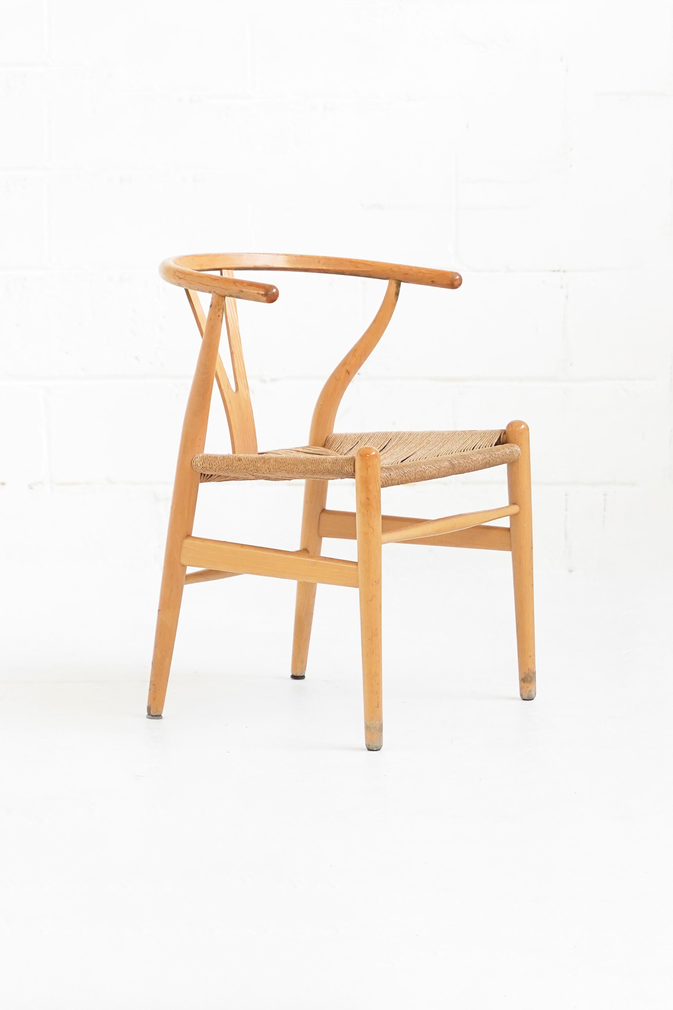 Stunning set of vintage oak wishbone dining chairs by Hans Wegner. They are in their original vintage condition with wear on danish cord and wood frame. A beautiful vintage look consistent with age of pieces.