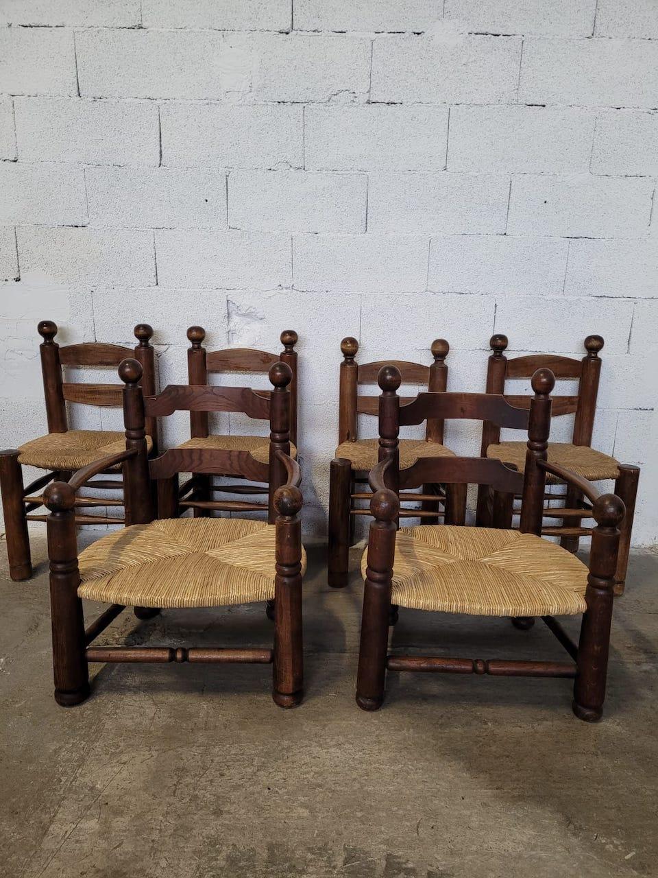 Set of 4 Charles Dudouyt 1940 chairs and 2 armchairs in oak and straw seats. The seats of the armchairs have been completely redone. 
Chair dimensions: H 84 x W48 x P38 Seat height: 44 cm 
Armchair dimensions H78 x W59 x P54 Seat height: 30 cm.