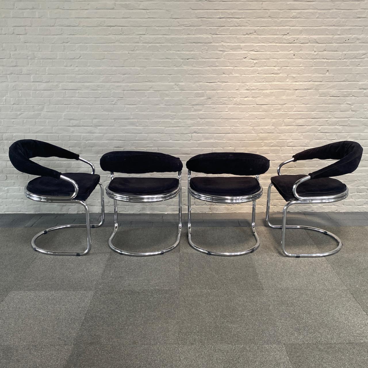 Set of 4 curved black velvet chairs with a chromed tubular frame.
These chairs are in very good vintage condition.
The black velvet upholstery is to our knowledge original.
Even the chrome plating is amazing; considering it is almost 50 years