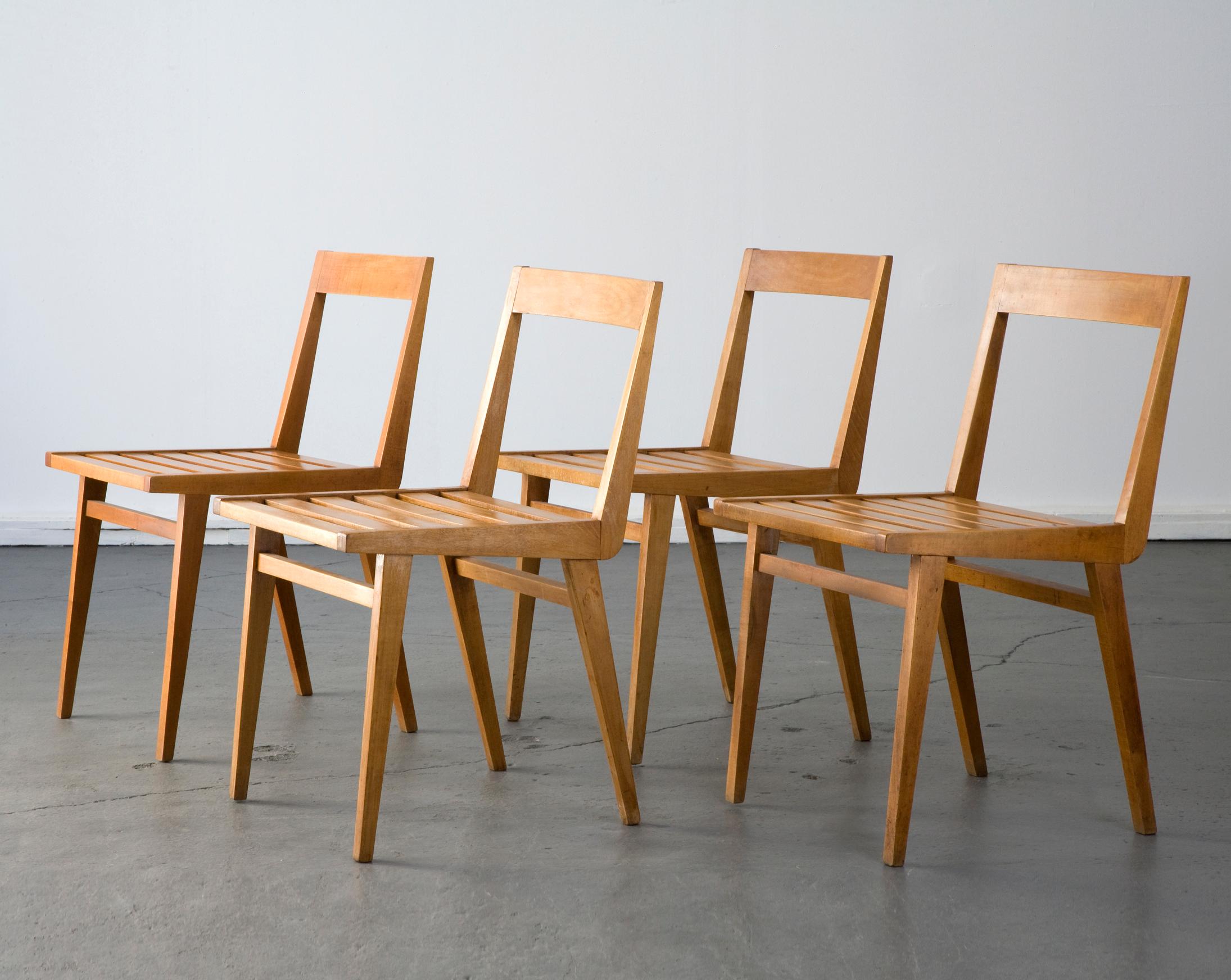 Set of four (4) chairs with slatted seat in pau marfim (ivory wood). Designed by Joaquim Tenreiro, Brazil, 1950s.