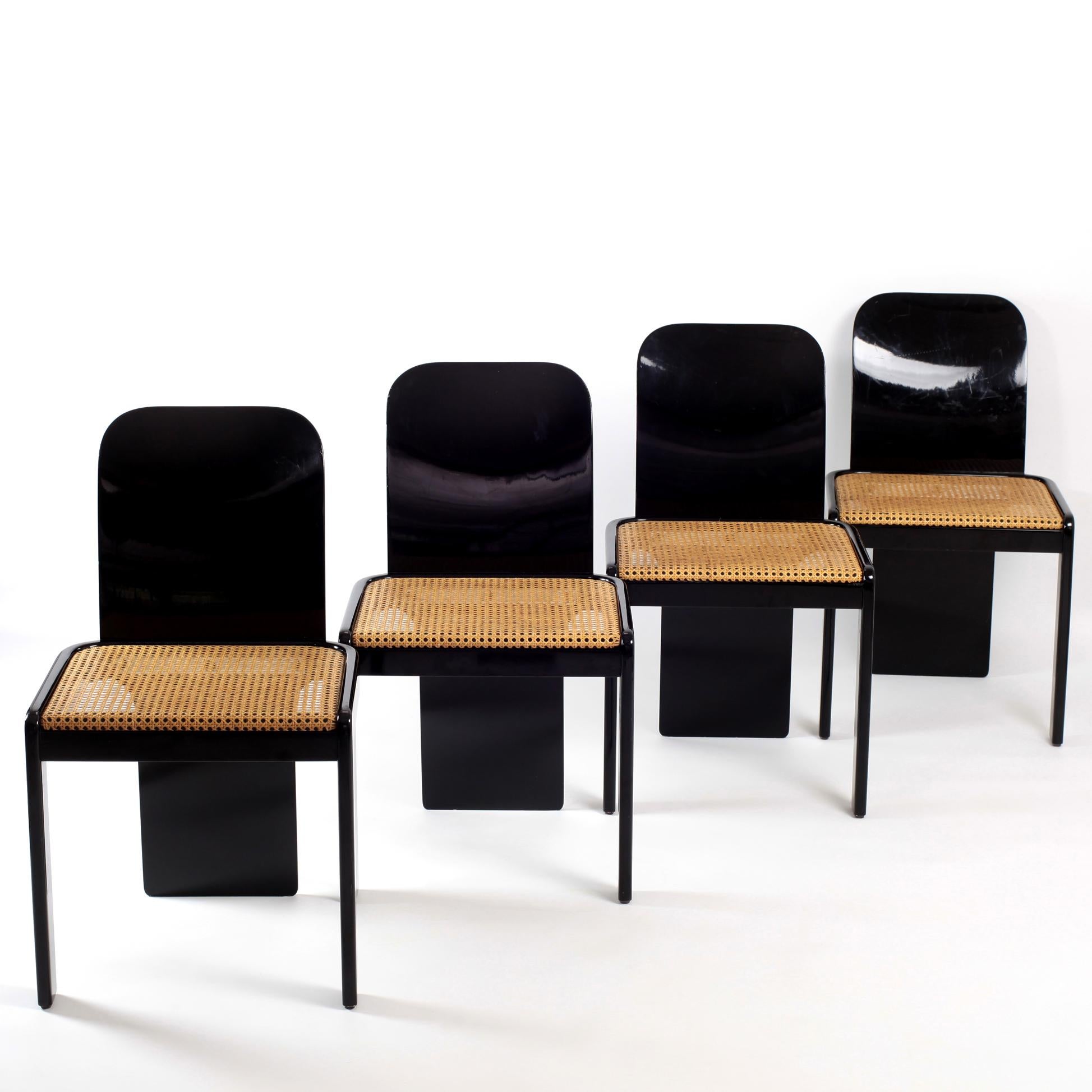Set of four italian dining chairs by Pierluigi Molinari for Pozzi Milano 1970s.
Structure in black lacquered wood with chrome detail.
Seating in natural Vienna straw - cane.