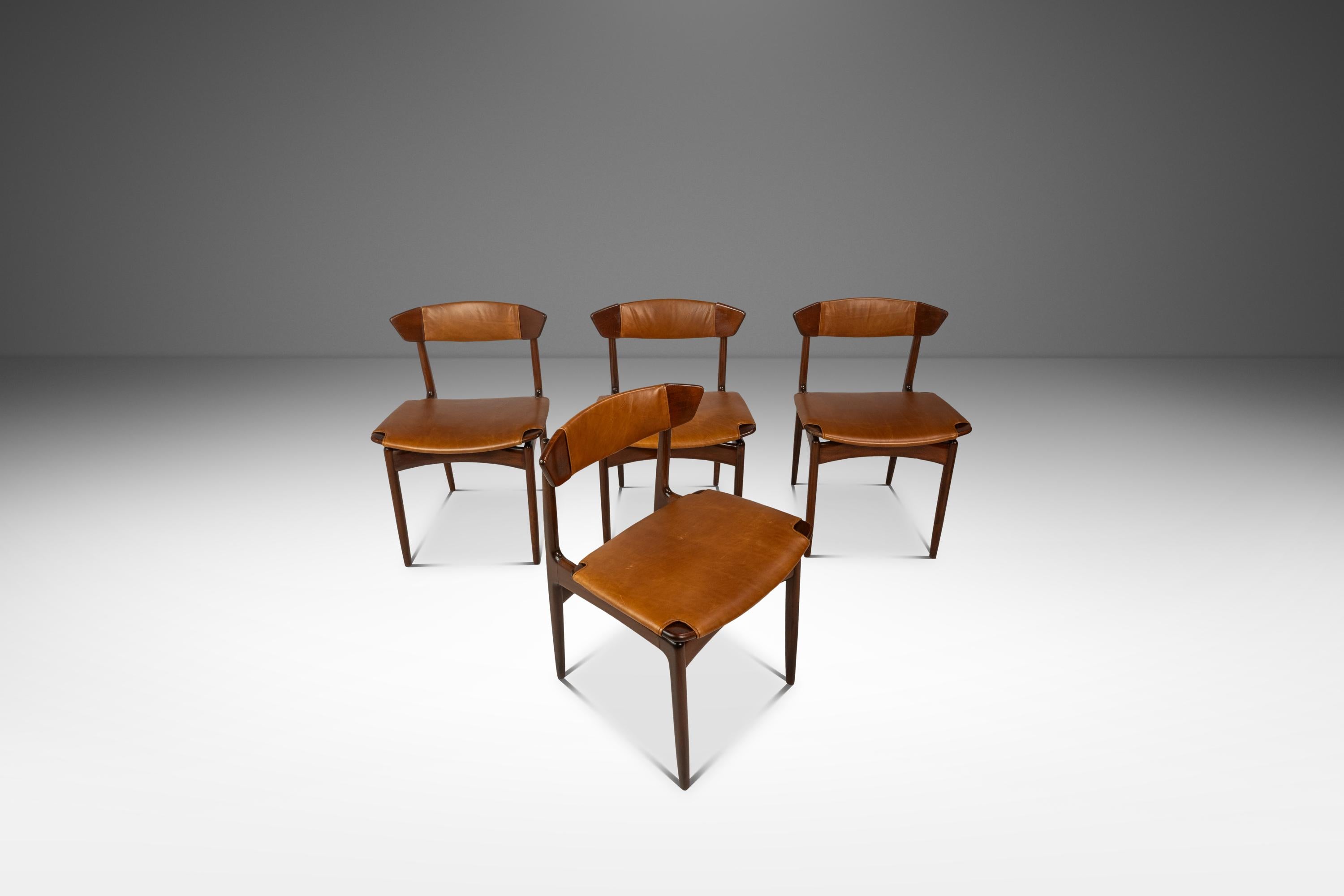 Introducing a rare set of Danish-made dining chairs designed by the incomparable Ib Kofod-Larsen for Selig. Constructed from frames of solid beech, stained walnut, this incredibly rare set of dining chairs features new leather upholstery cut from a