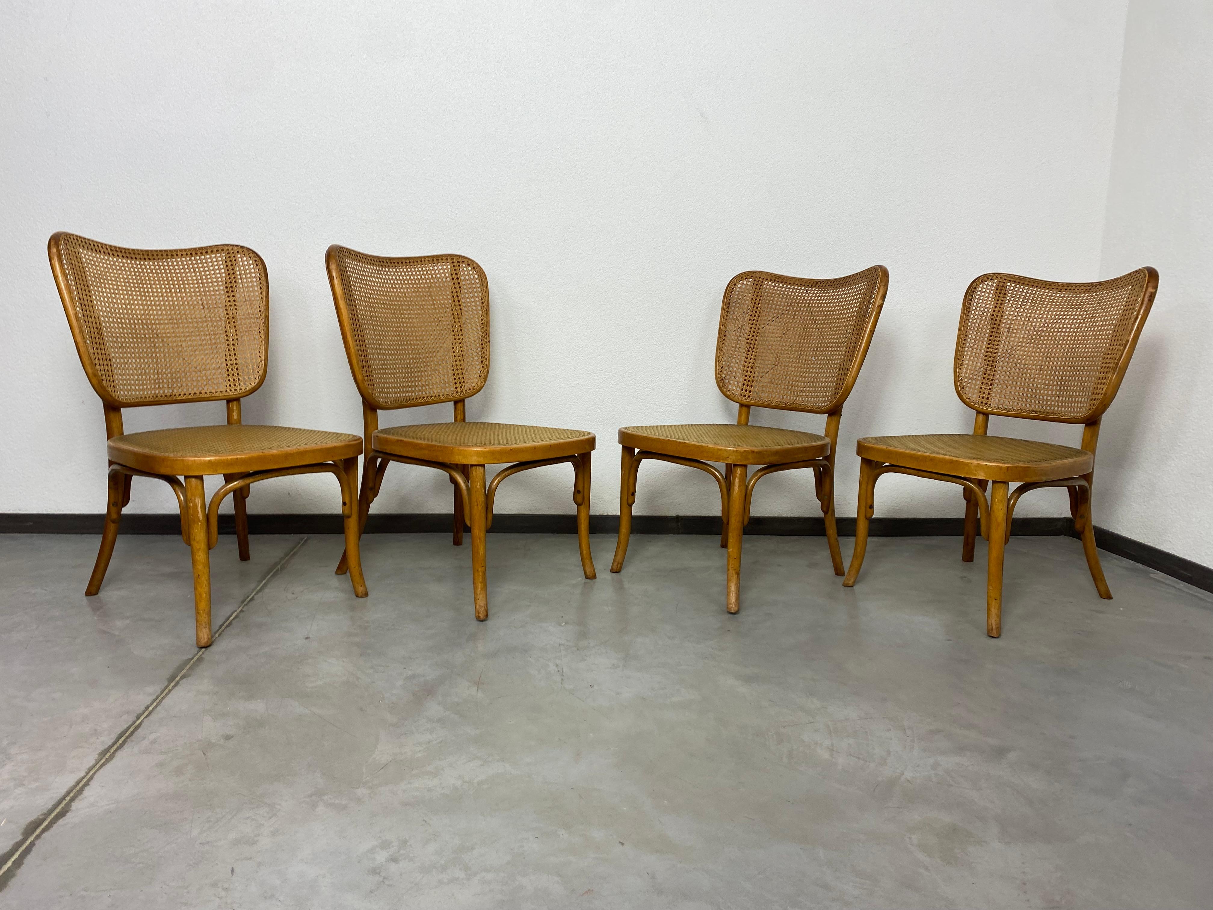 Set of 4 chairs model A821 by Adolf Gustav Schneck for Thonet Mundus. Absolutely original condition, combination of natural rattan weave on the backrest and rubber weave on the seat.