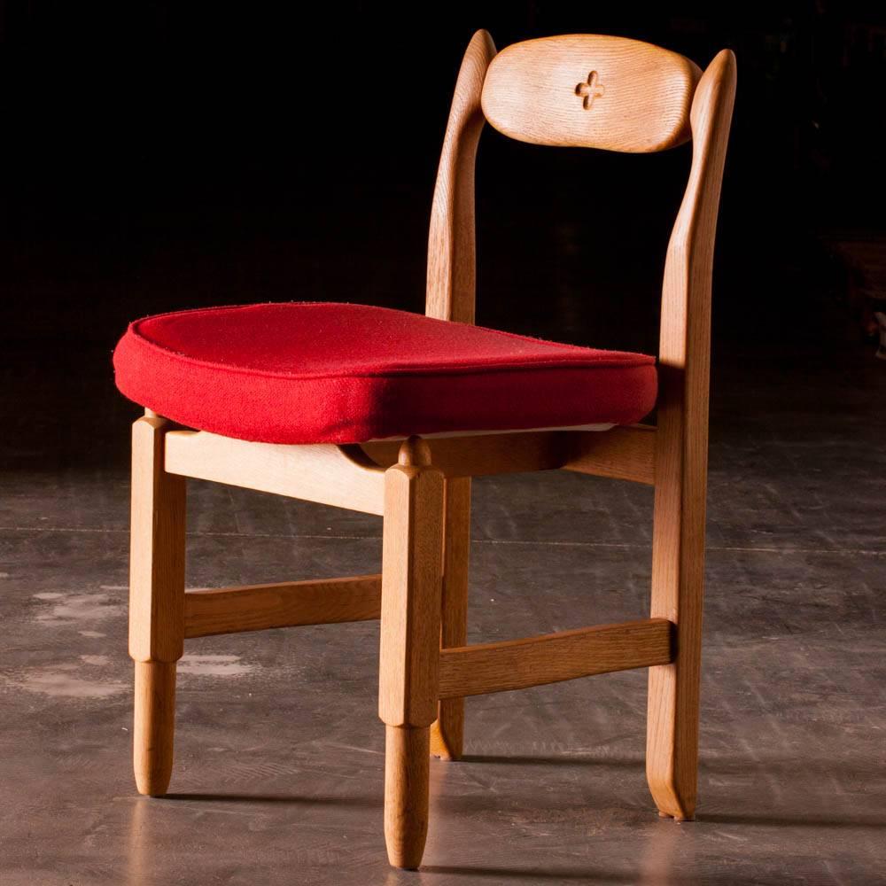 Lovely set of four dining room chairs with original upholstery. Made in oak, those chairs are very decorative. Each chair has a little cross in the back.