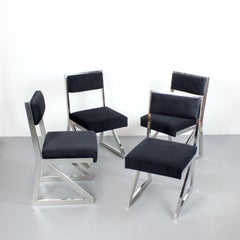 Set of 4 chairs with chrome-plated steel frame and black upholstey