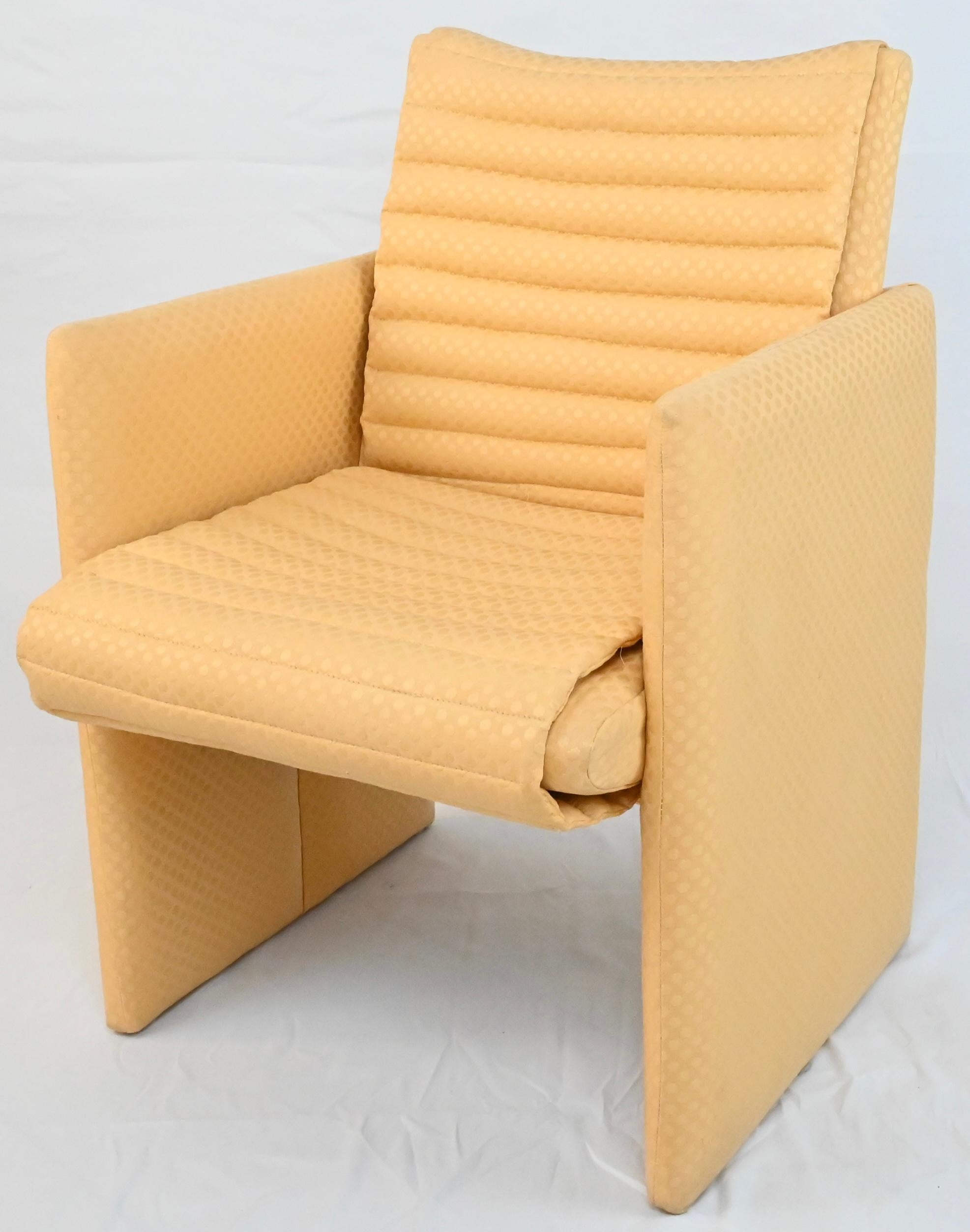A fine and rare set of 4 upholstered armchairs with quilted channels that are tufted with very good quality pale yellow fabric. The true color of the fabric can be viewed in the last 2 images. Photograph lighting did not capture this in all photos.
