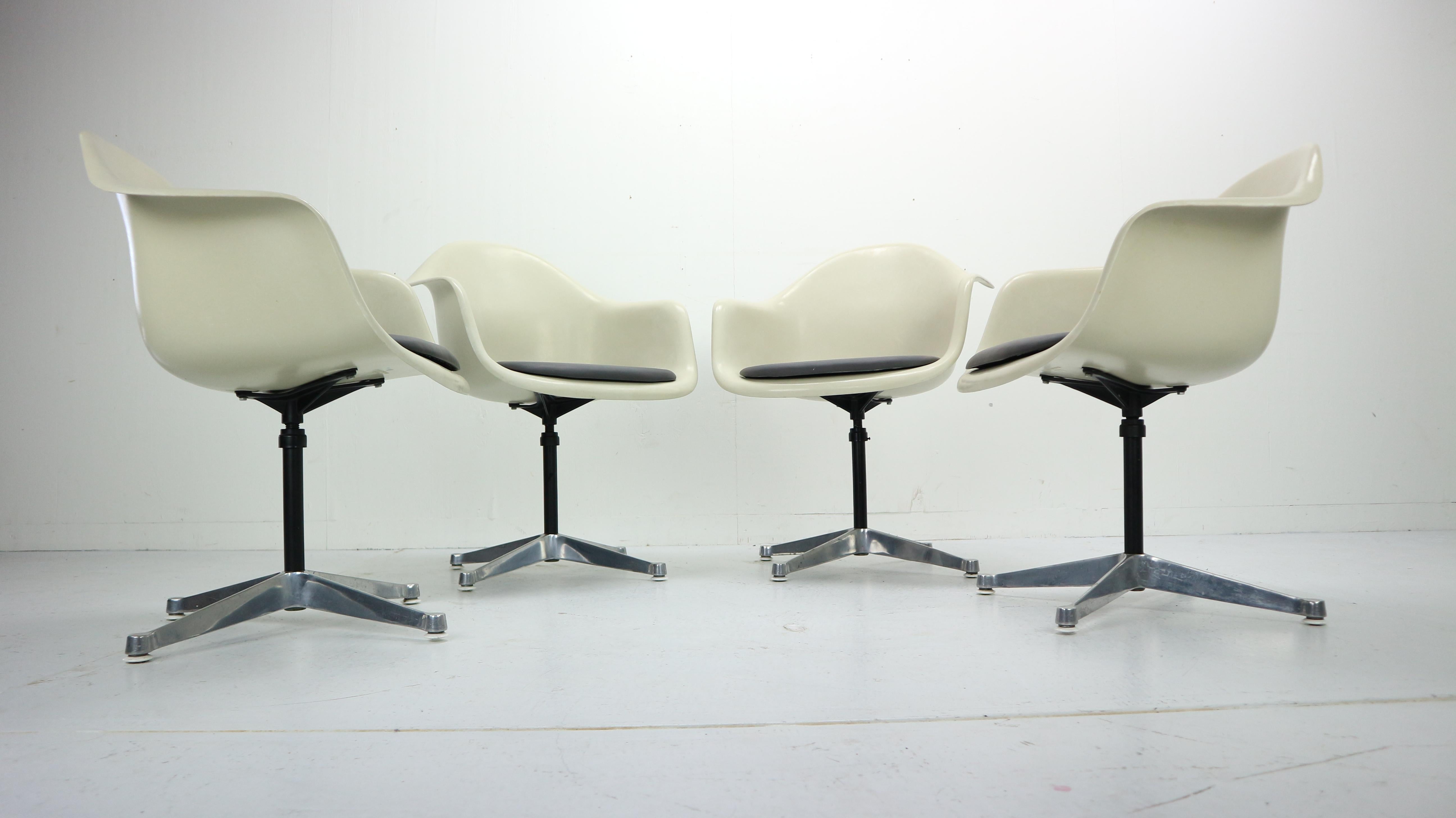 Set of 4 Mid-Century Modern swivel chairs designed by Charles Eames in 1950s.
This is one of the very well classic designs by Charles Eames made for the Herman Miller Company. 

The fibreglass model bucket formed tub chair with arms, raised on a