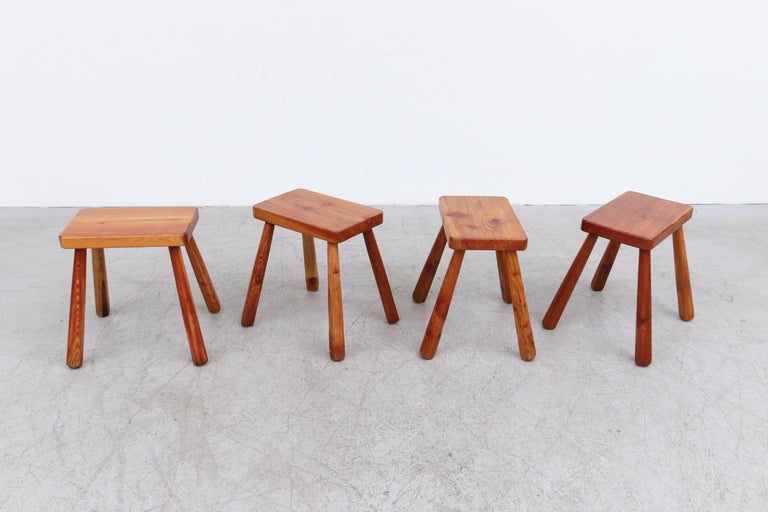 Set of 4 Italian pine stools inspired by Charlotte Perriand. In Good Original Condition with Normal Wear for their Age and Use. Sold as Set of 4. Top measures 15.375 x 9.75 x 1.5.