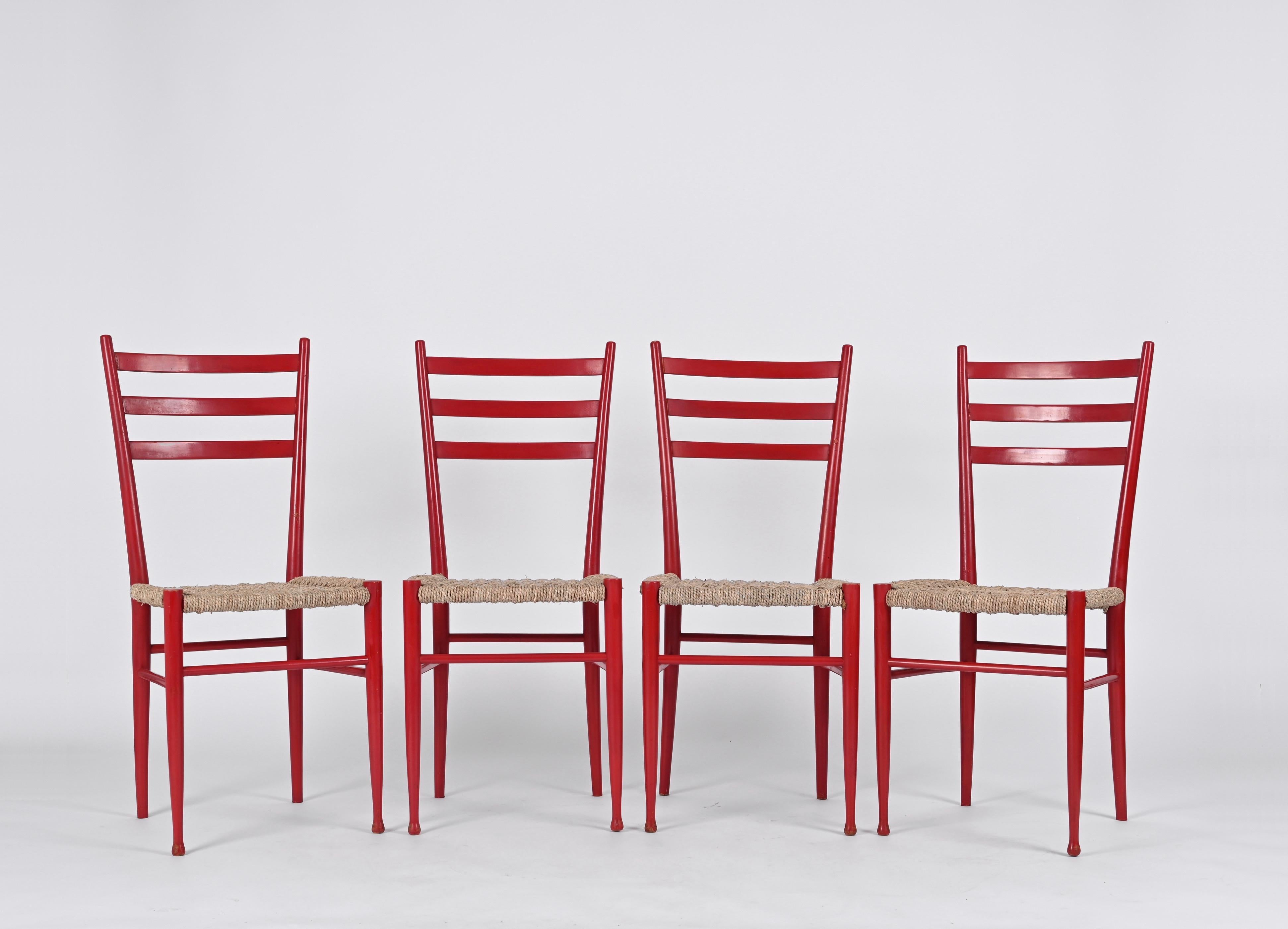 Beautiful Set of 4 Chiavarine chairs 3 slats model. These extremely light chairs were designed by the Levaggi brothers in the 1950s in Chiavari, Italy.

The chairs feature a structure in polished and red-stained beech wood with the seat in