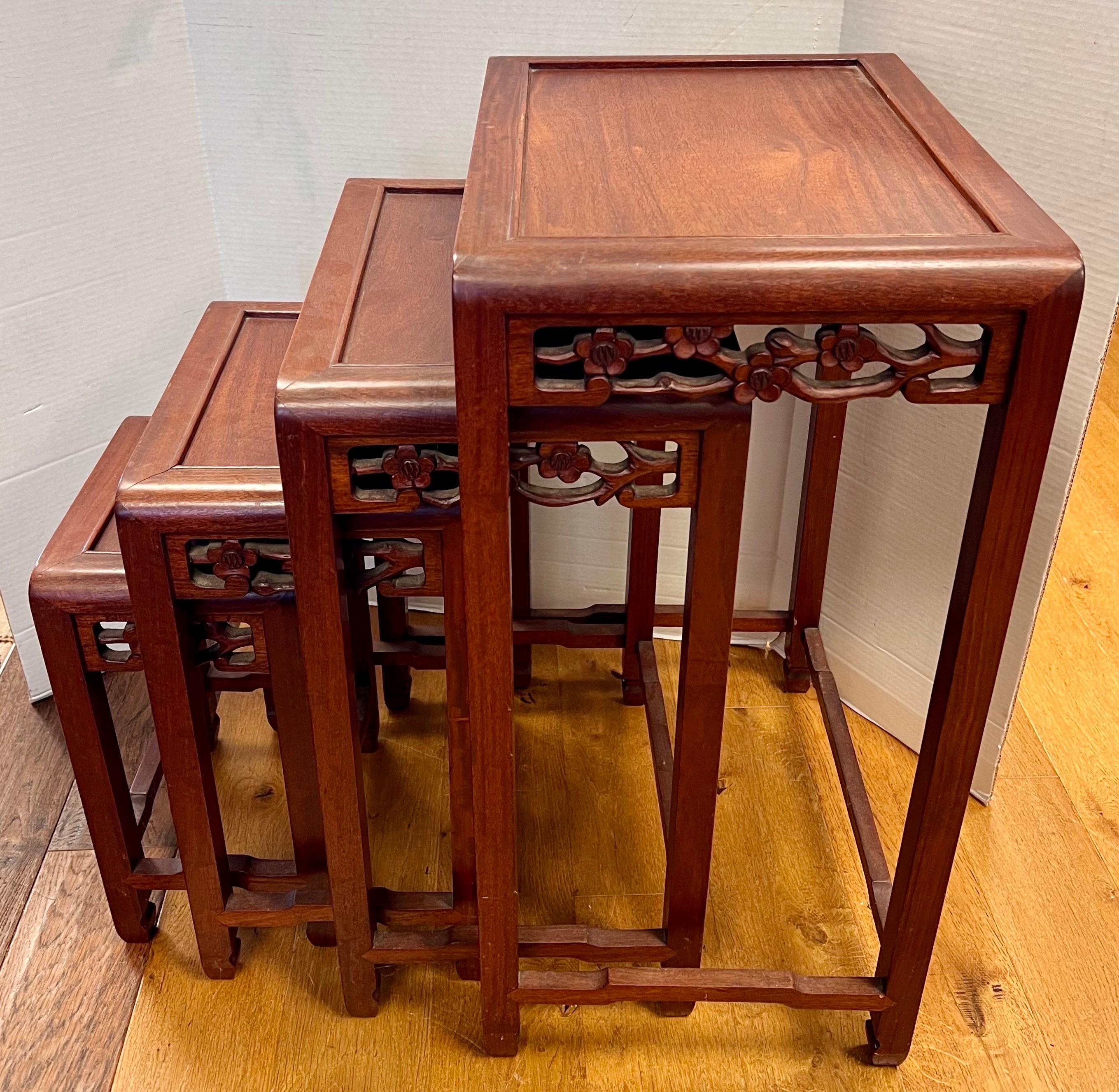 Set of 4 Chinese Asian Carved Nesting Tables feature hand-carved details, showcasing the artistry and craftsmanship of Chinese design. Crafted with precision and care, these nesting tables effortlessly combine functionality and beauty, allowing you