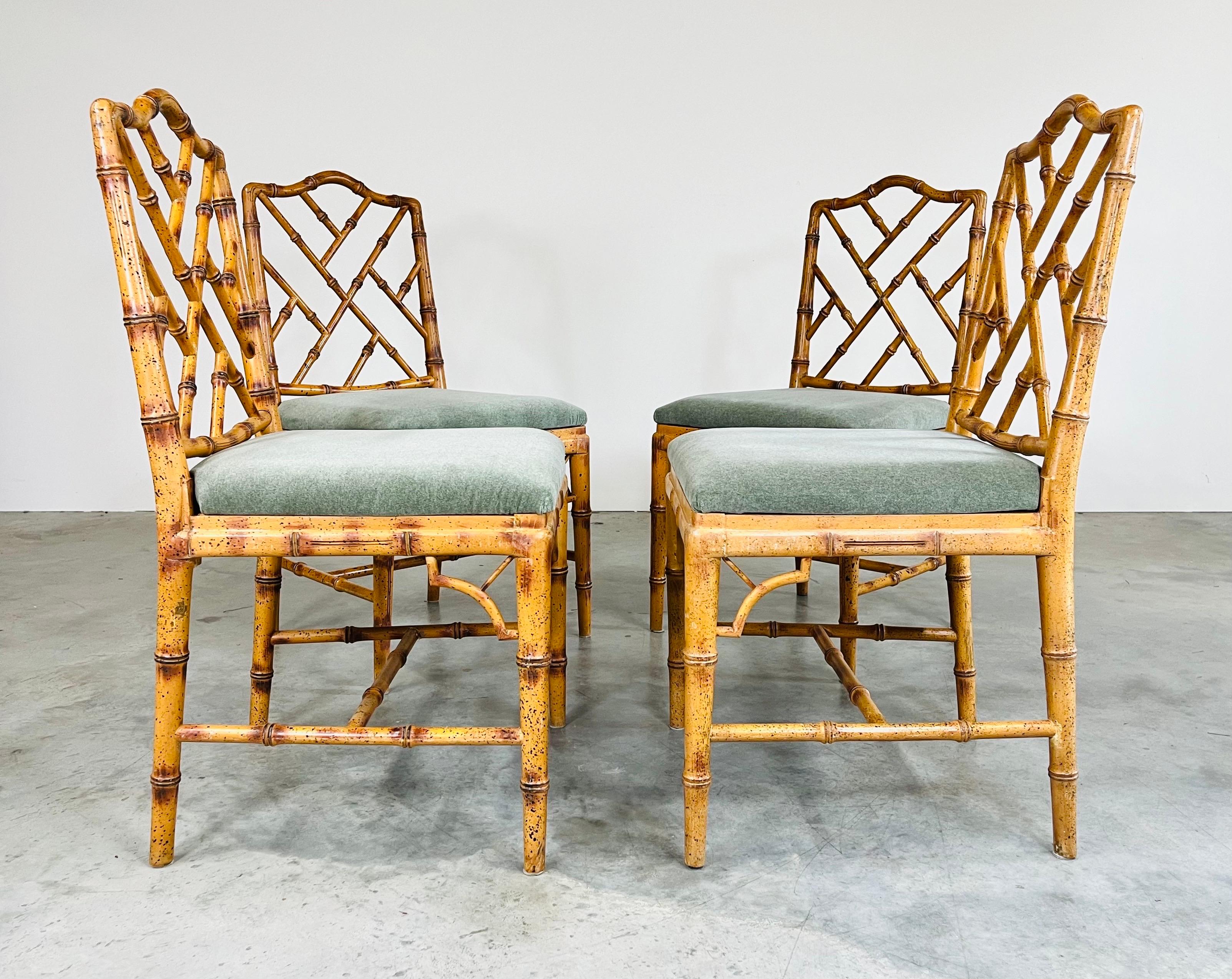 A beautiful set of 4 faux bamboo side chairs in the Chinese Chippendale style having new upholstery and seat strapping along with solid carved wood frames. In excellent condition and ready for use. 
North America circa 1975. 
36x19x20” HWD SH 19”