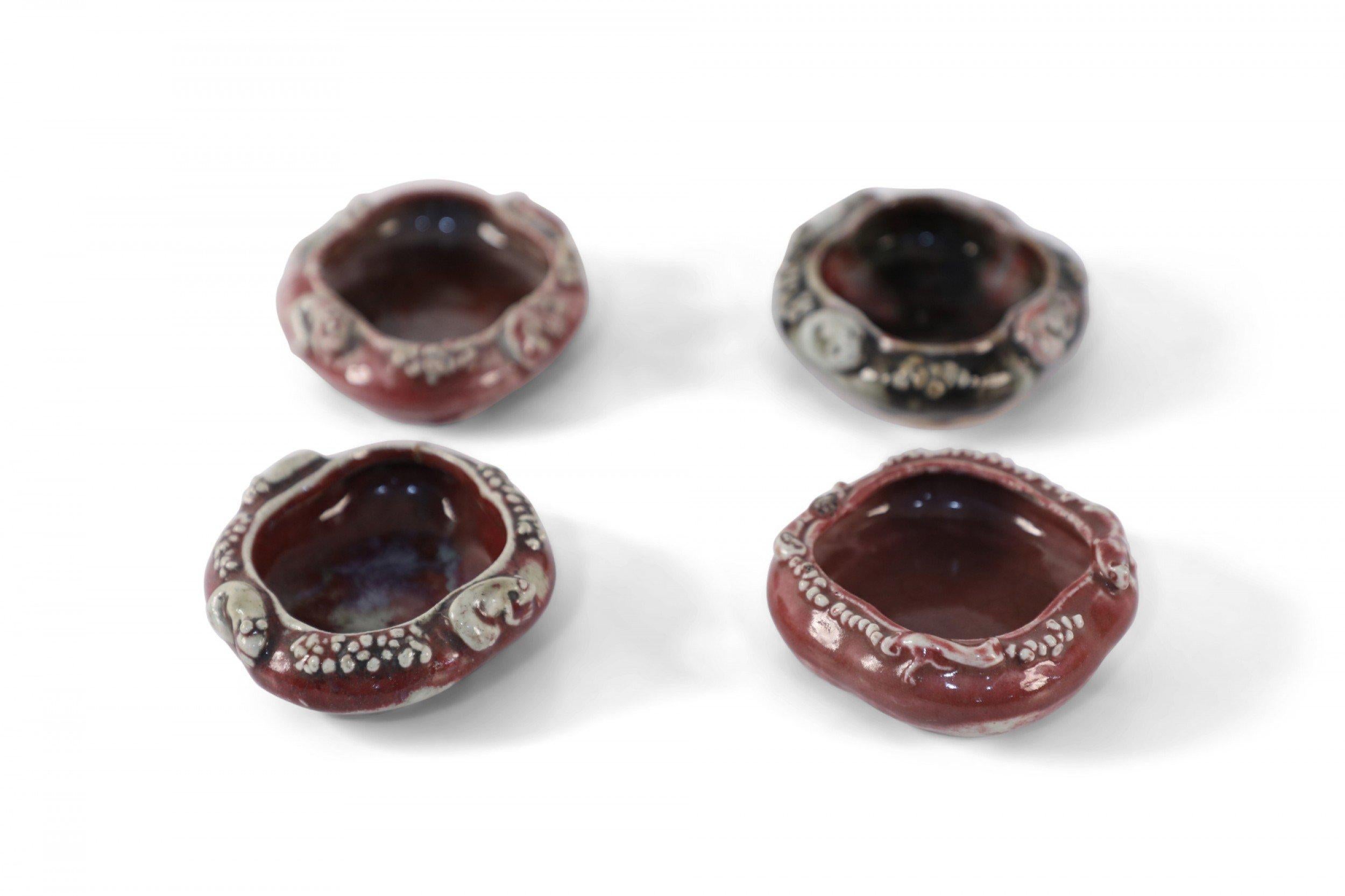 Set of 4 Chinese red glazed porcelain catchalls with organic forms decorated in raised depictions of frogs around the exteriors (priced as set).
     