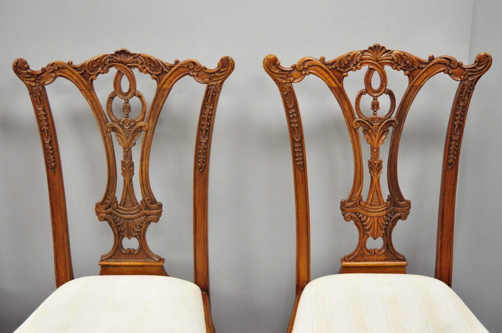 Set of 4 reproduction Chippendale style mahogany ball and claw dining chairs. Listing includes 4 Chippendale style side chairs, solid wood construction, beautiful wood grain, upholstered seats, nicely carved details, and carved ball and claw feet,