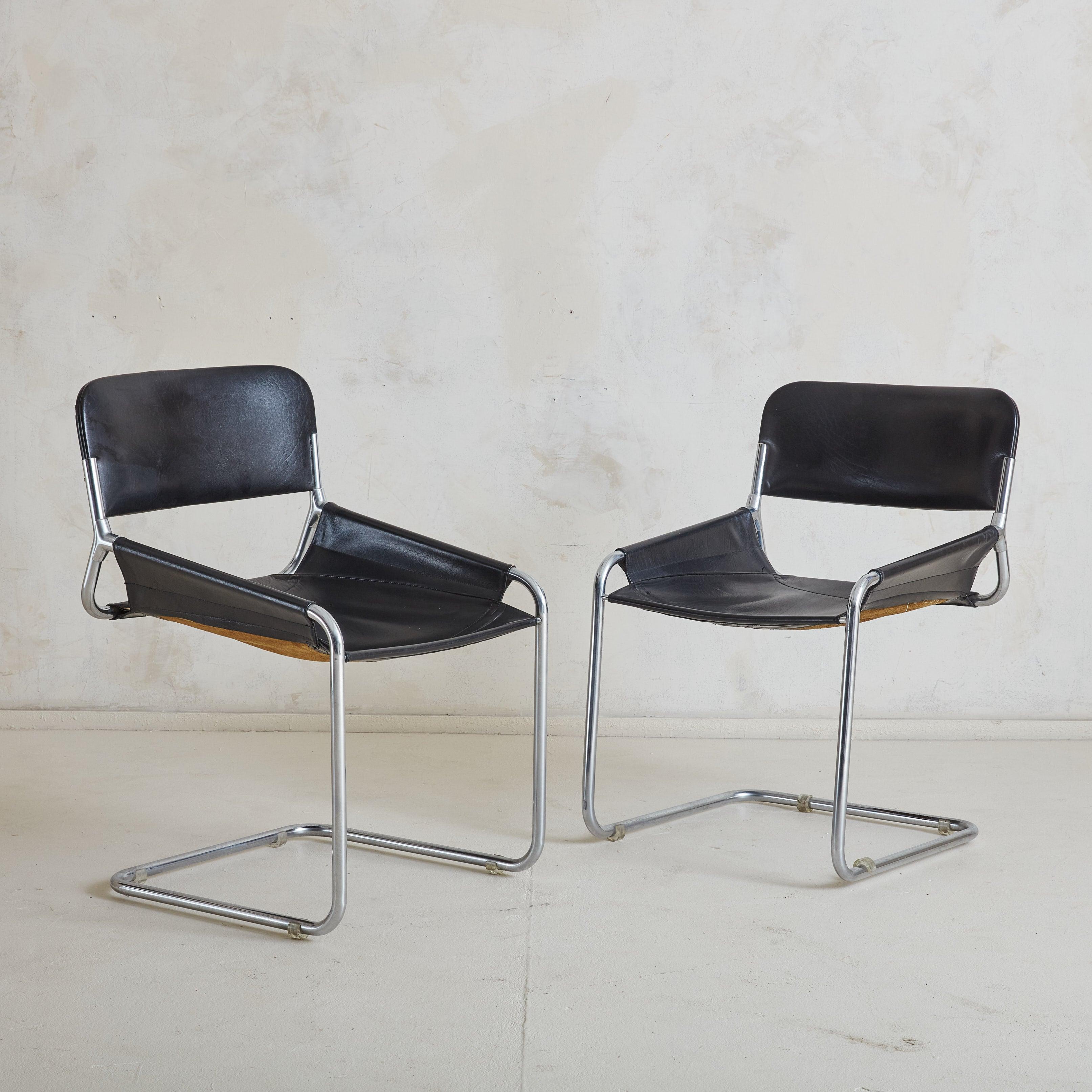 A masterclass in minimalist design, these 1970s Italian chairs feature polished tubular chrome frames that effortlessly suspend high-quality black leather sling seats. The ergonomic design allows the leather to mold to the sitter’s form, while the