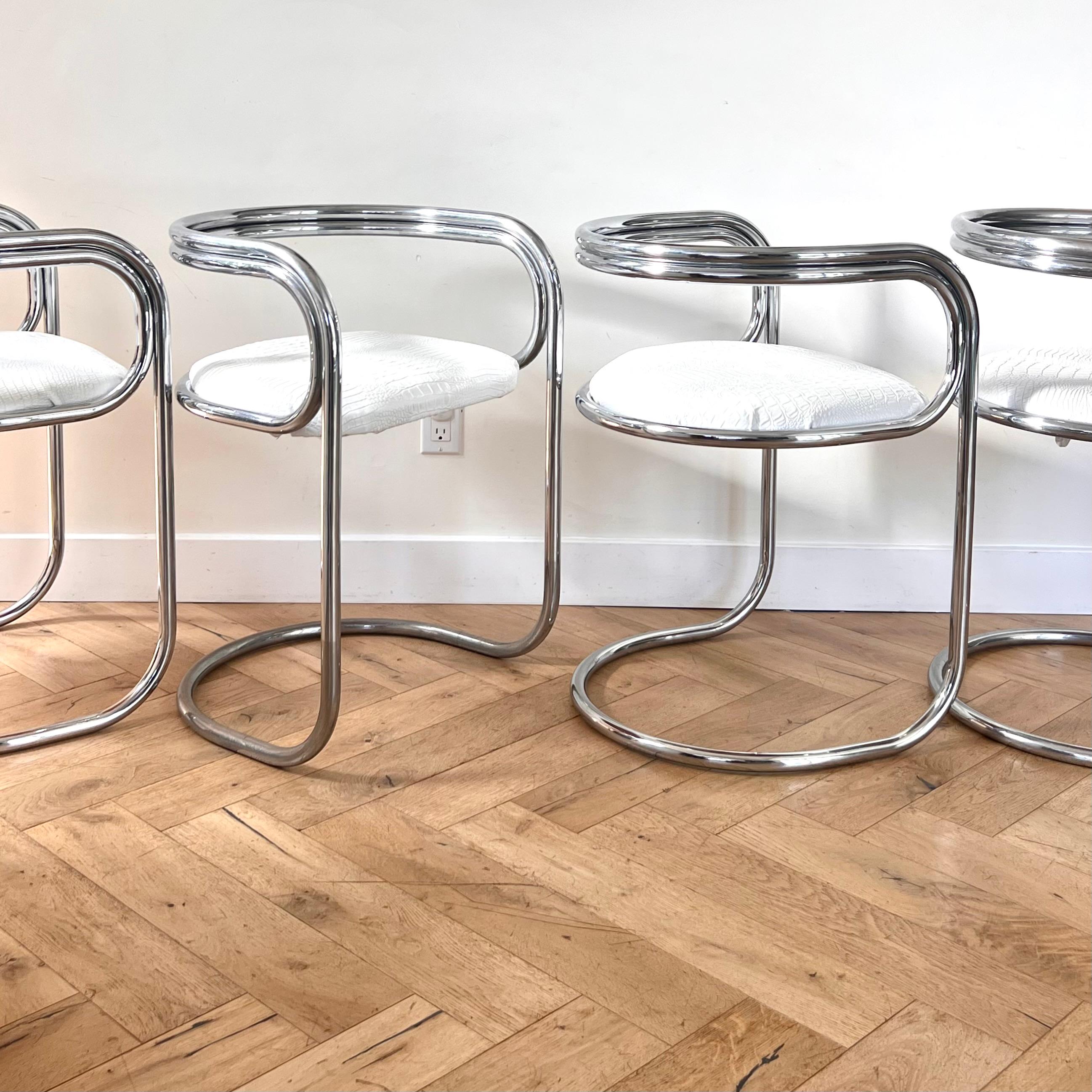 A set of four cantilever chairs designed by Peter Wigglesworth for Plush, circa 1970. In chrome-plated tubular steel and white faux leather upholstery with python motif. Fabulous condition. Pick up in LA or we ship worldwide; please don’t hesitate