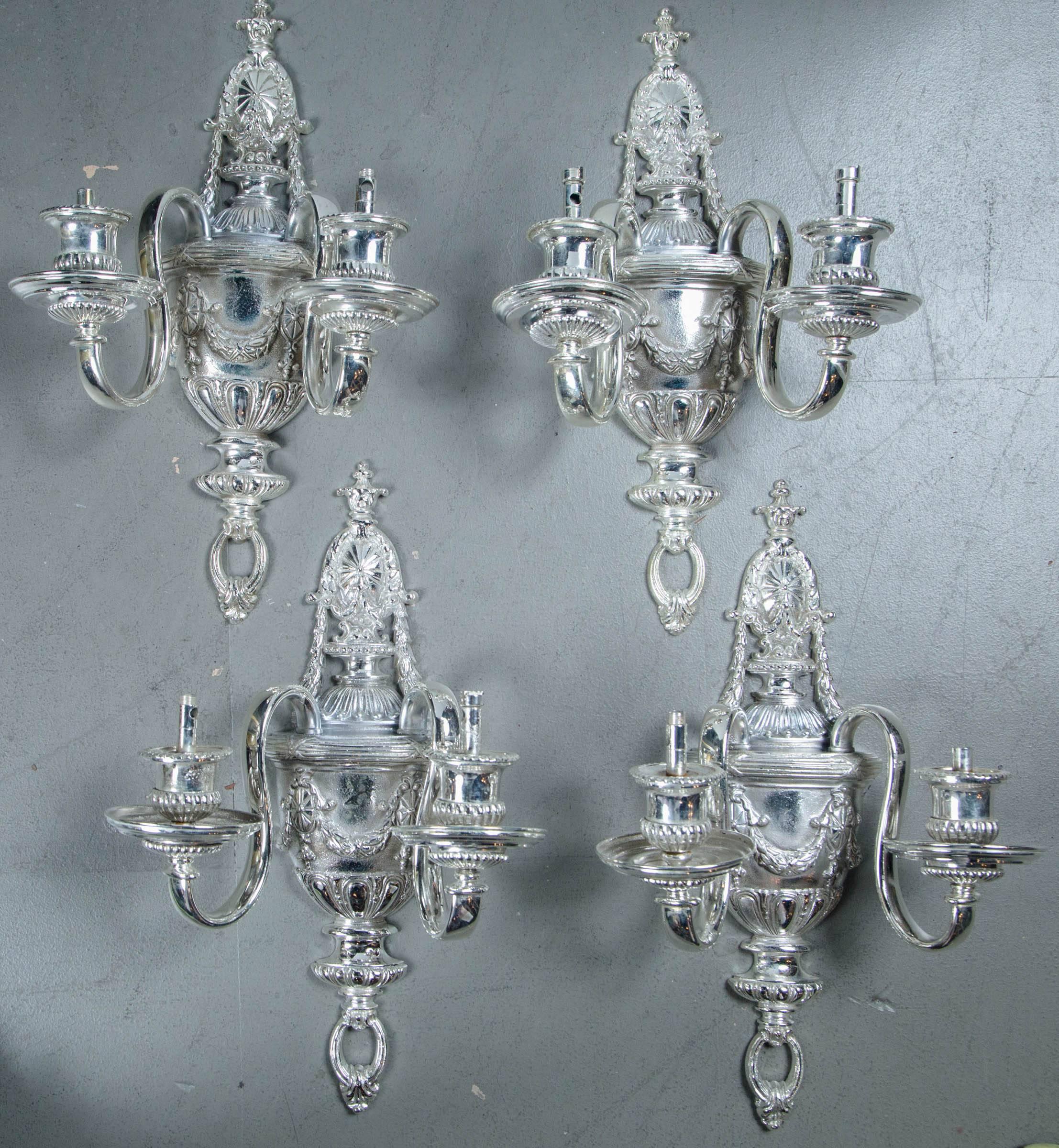 A set of four circa 1920 silver plated sconces; $4,800 per pair, two pairs available.