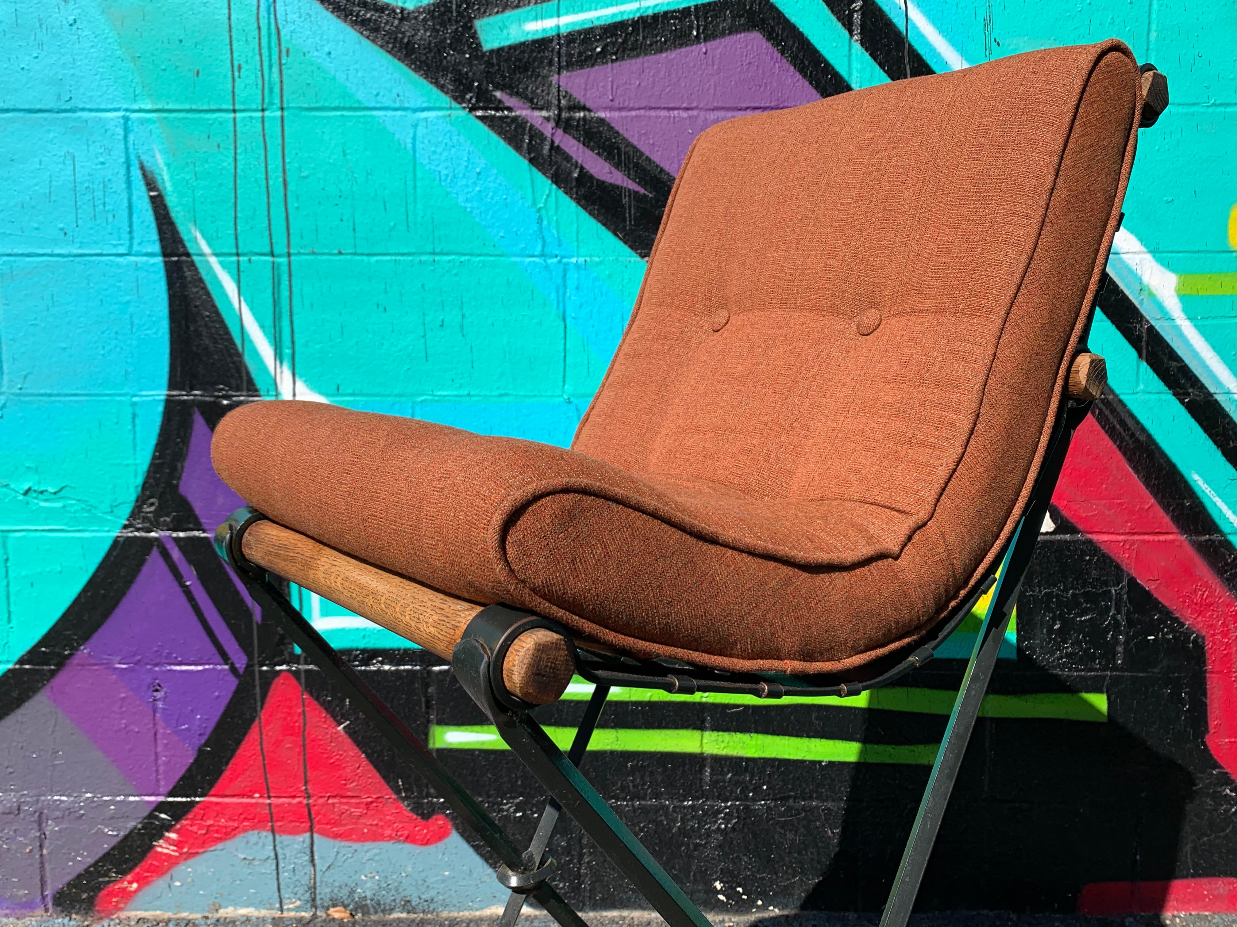 A unique set of solid oak and iron scoop seat barstools by Cleo Baldon, circa 1970s.Newly reupholstered in high grade sunbrella fabric. Extremely solid and comfortable.