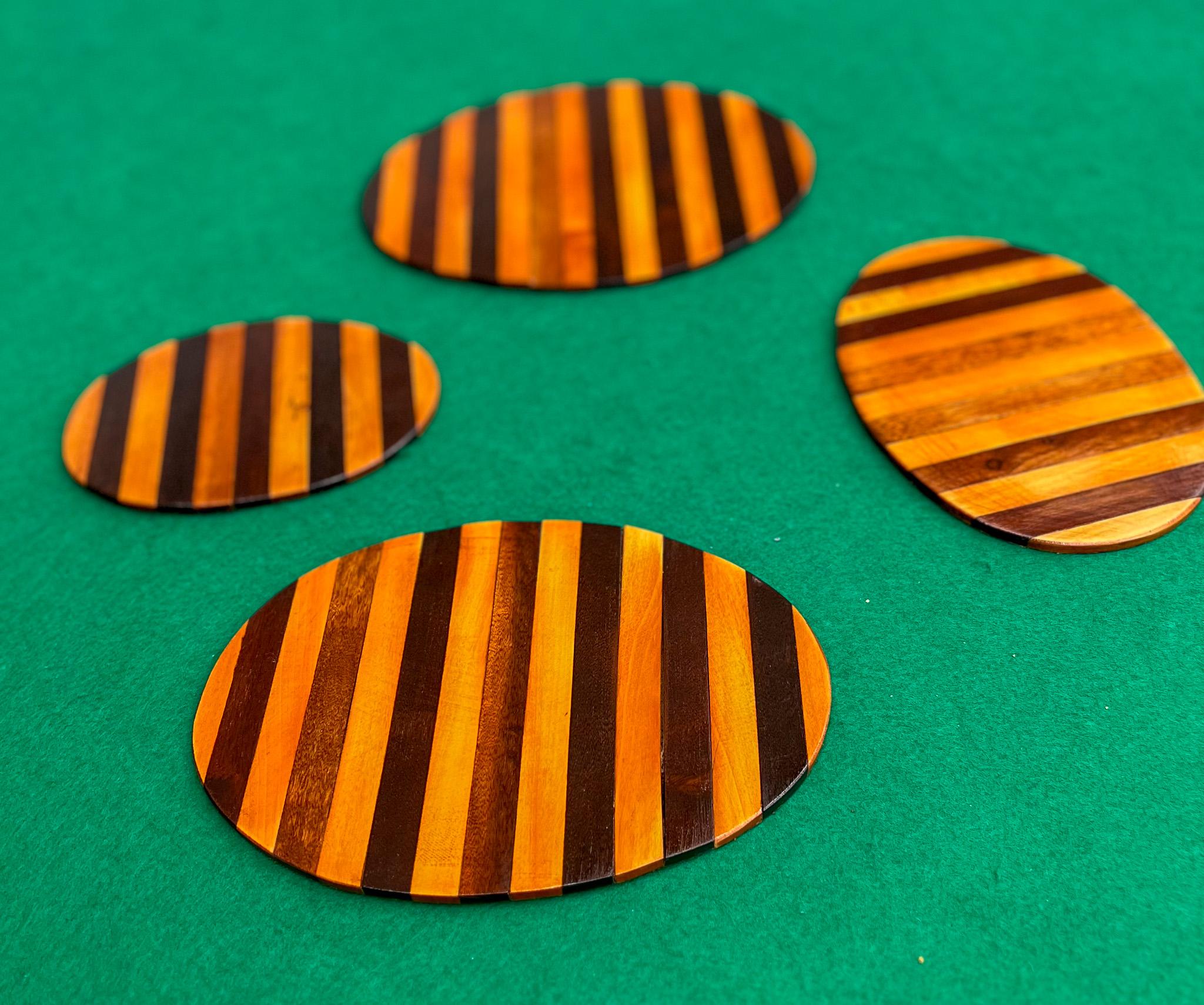 This set of four coasters are handcrafted with Brazilian rosewood (also known as jacaranda) and feature a beautiful design with clean lines. It has a striped pattern with a mix of light and dark brown rosewood. The wood has a deep, dark, and rich