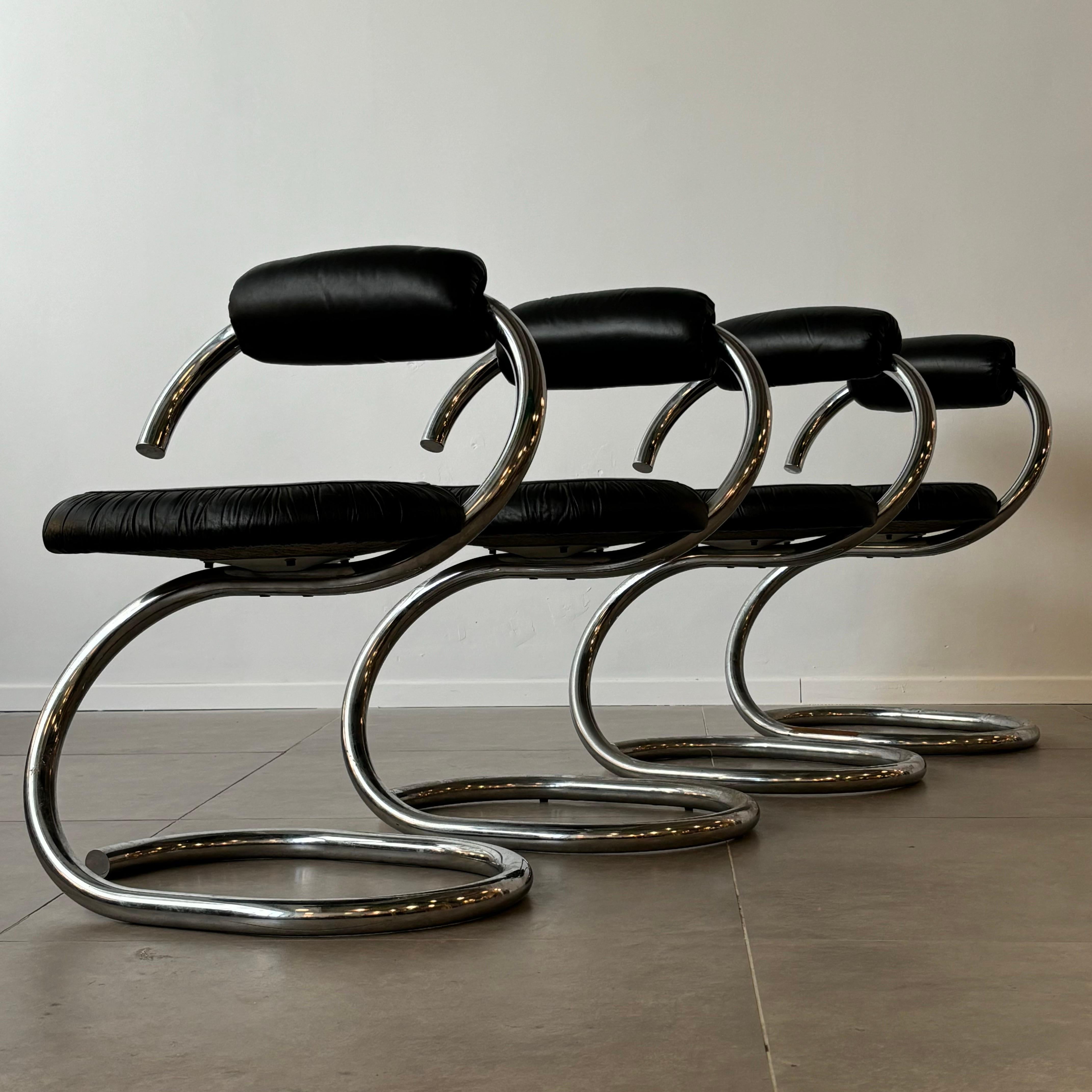 This collection comprises four Italian Cobra chairs, meticulously designed by Giotto Stoppino during the 1970s. Notable for their cantilevered design, these chairs showcase gracefully curved, tubular chrome frames that flow seamlessly from the base