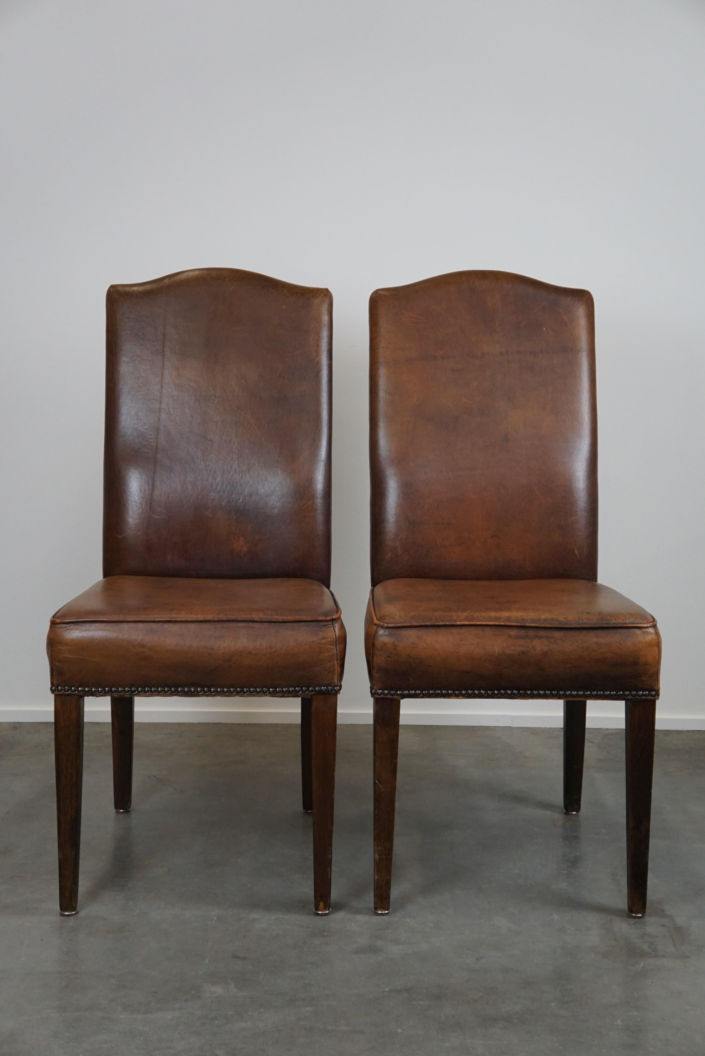 Offered is this beautiful set of four cognac-colored sheep leather dining chairs with a beautiful patina. Through responsible use, this beautiful set of sheep leather dining chairs has acquired a lovely patina, making them even more attractive.