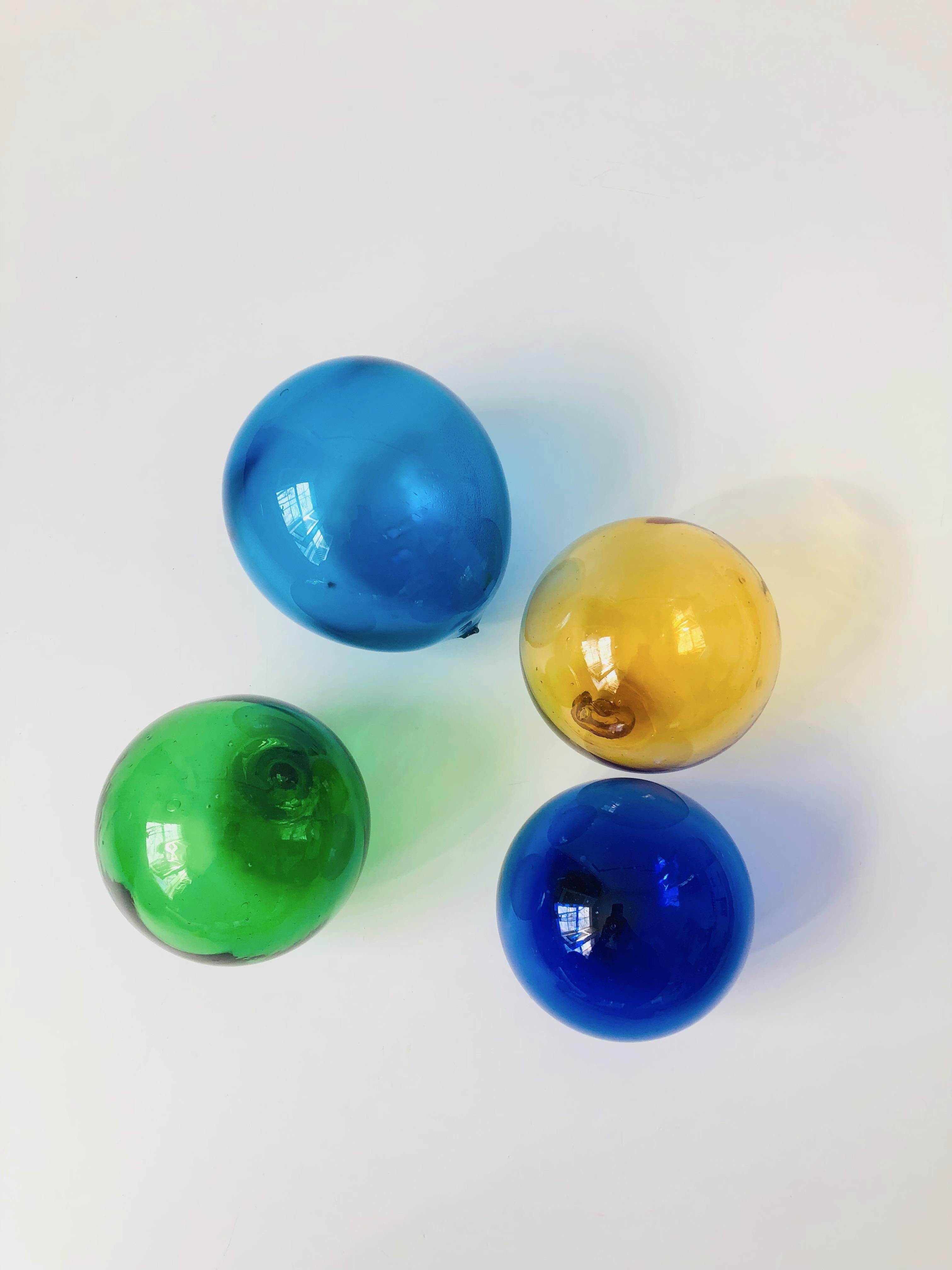A wonderful set of 4 colorful vintage glass fishing floats. Made of blown glass in slightly varying sizes.
Measure approximately 3.5