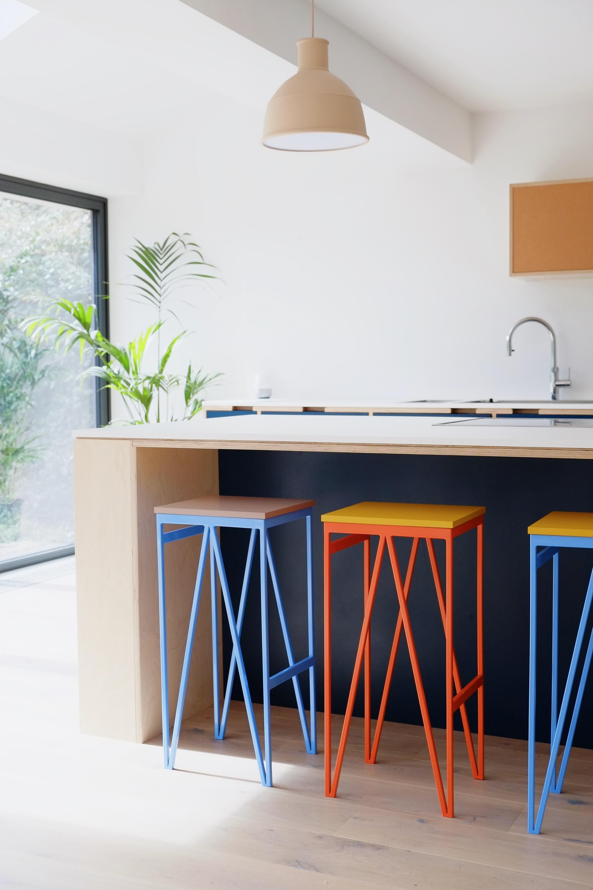 The kitchen counter stools are part of & New’s color play dining room collection, which consists of dining tables, benches, stools, and cabinets made in Britain by local craftsmen.

The design of the collection was driven by function and the