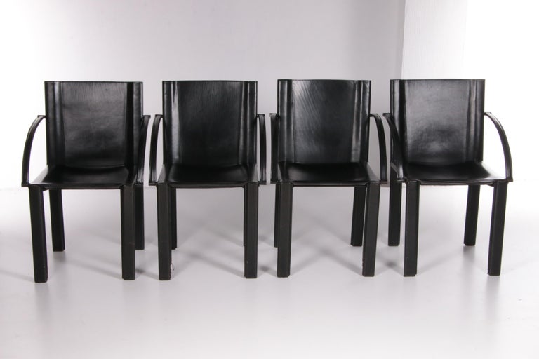 A beautiful set of four black leather armchairs designed by Carlo Bartoli around the 1980s.

Both the foot and armrests are covered with black leather, which gives the chair a luxurious and finished look. These chairs are perfect for the dining room