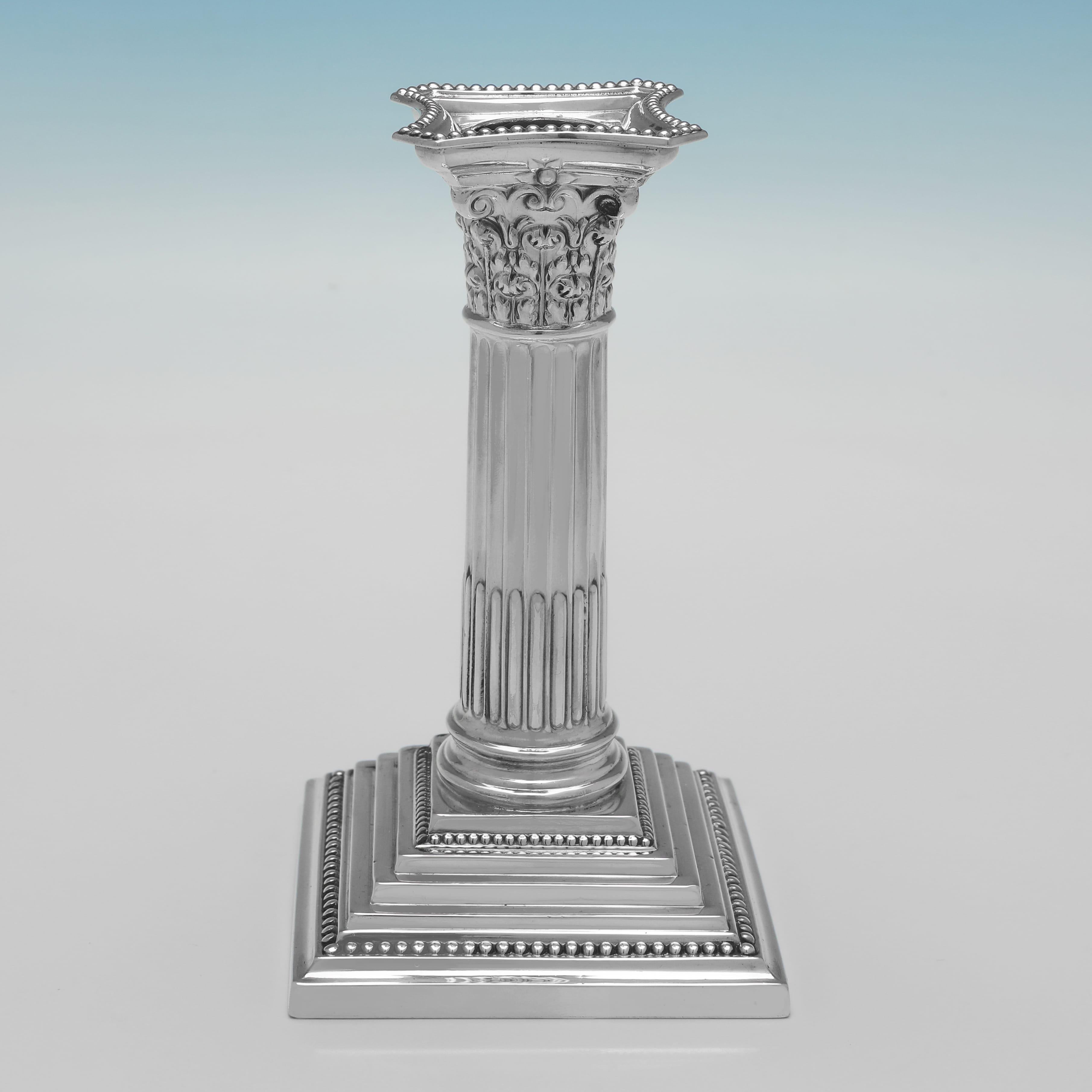 Hallmarked in Sheffield in 1956 by Garrard & Co., this handsome, set of 4, Elizabeth II period, Sterling Silver Candlesticks, are in the corinthian column style, with stepped bases and bead borders. 

Each candlestick measures 5.25