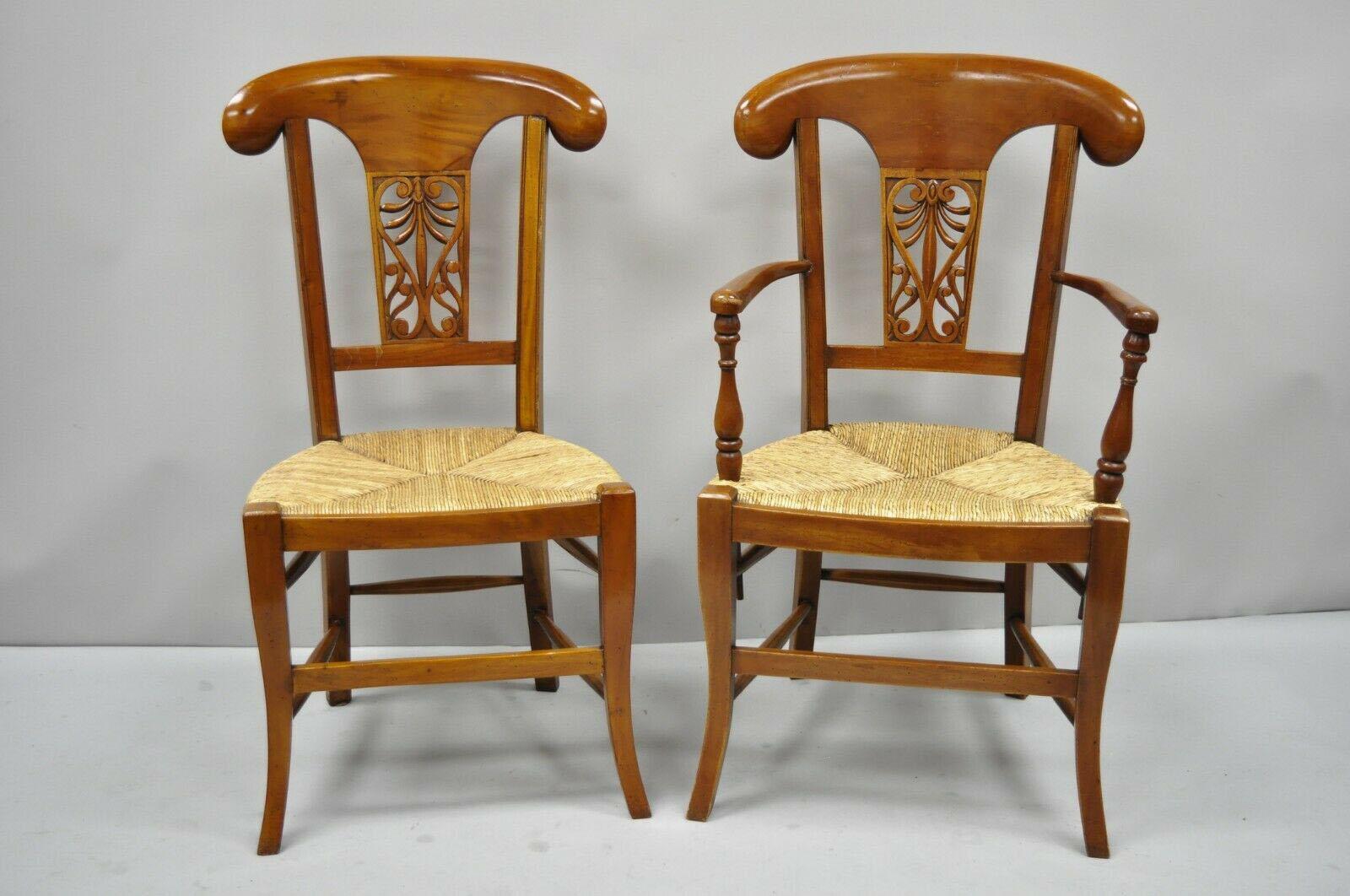 Set of 4 country French Provincial carved cherrywood rush seat dining chairs. Items feature woven rush seat, loose cushion, solid wood construction, distressed finish, nicely carved details, great style and form, circa late 20th century. Measures: