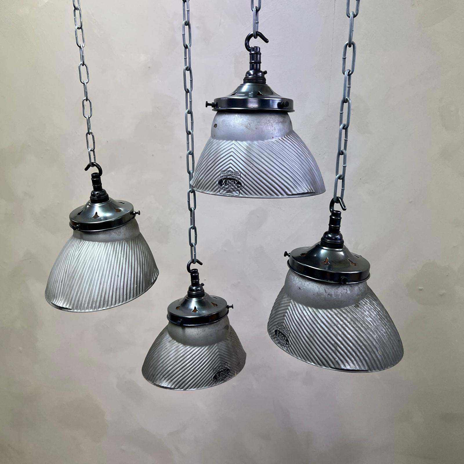 Set of 4 Belgian, Mercury Glass Pendant lights with galleries. 
All fitted with a bulb holder and hook ready to be installed.
The reflectors were made by Curtis lighting in the 1930's, (all stamped).
These give off a really warm glow when
