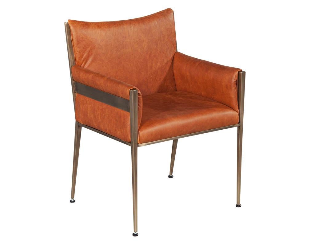 Set of 4 custom modern leather dining chairs cognac leather. Custom made by Carrocel. Finished in a butter soft natural Italian cognac leather and aged brass finish.

Price includes complimentary scheduled curb side delivery service to the