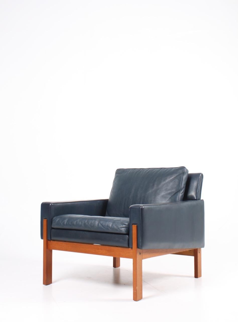 Great looking lounge chairs in petrol blue patinated leather with solid teak frame. Designed and made in Denmark 1960s. Original condition.