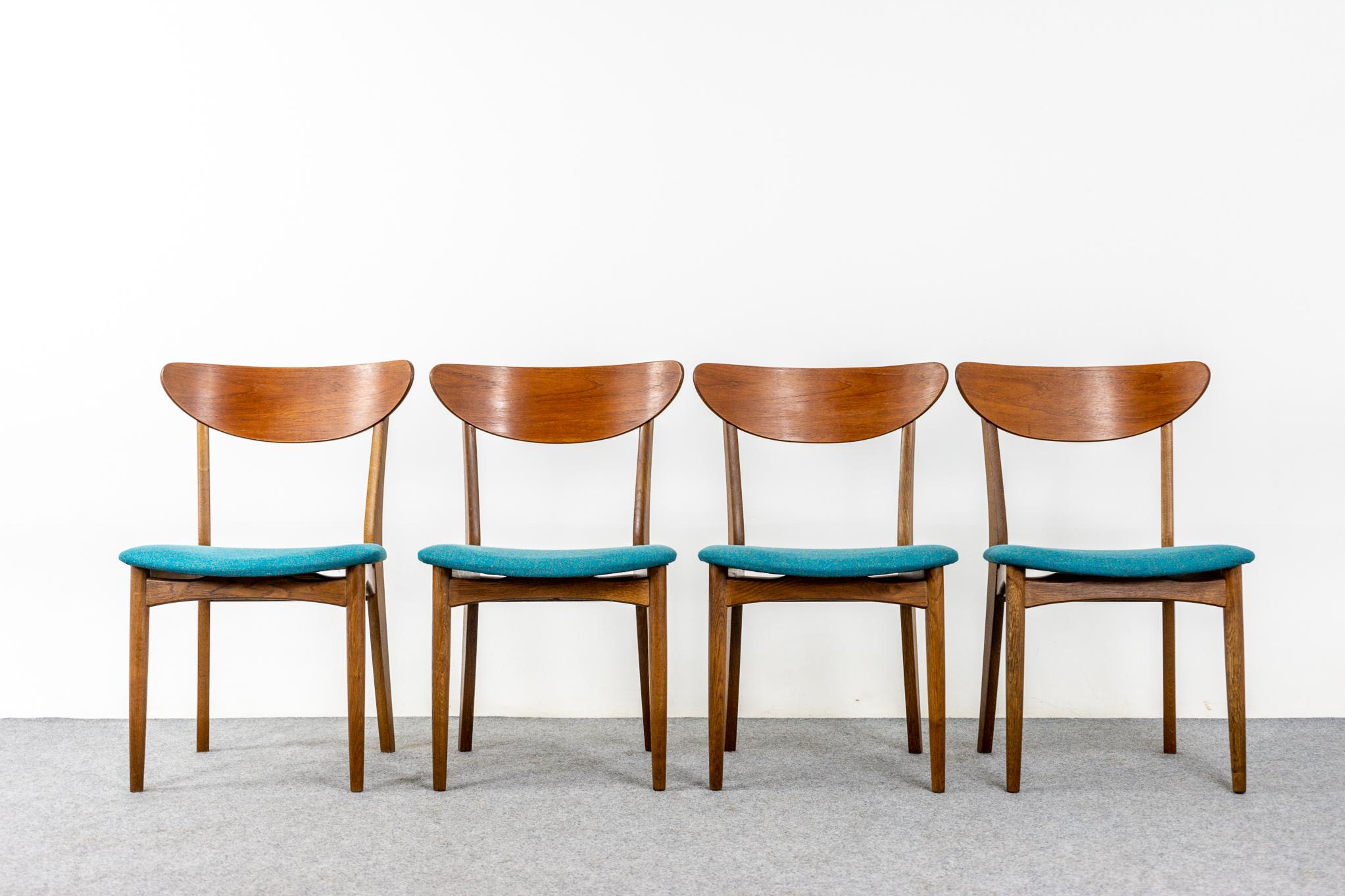 Teak & oak Danish dining chairs, circa 1960's. Beautifully curved backrests and generous seat design provide support and comfort. Solid wood legs feature cross braces for added stability and support. Floating seat design adds an air of lightness and