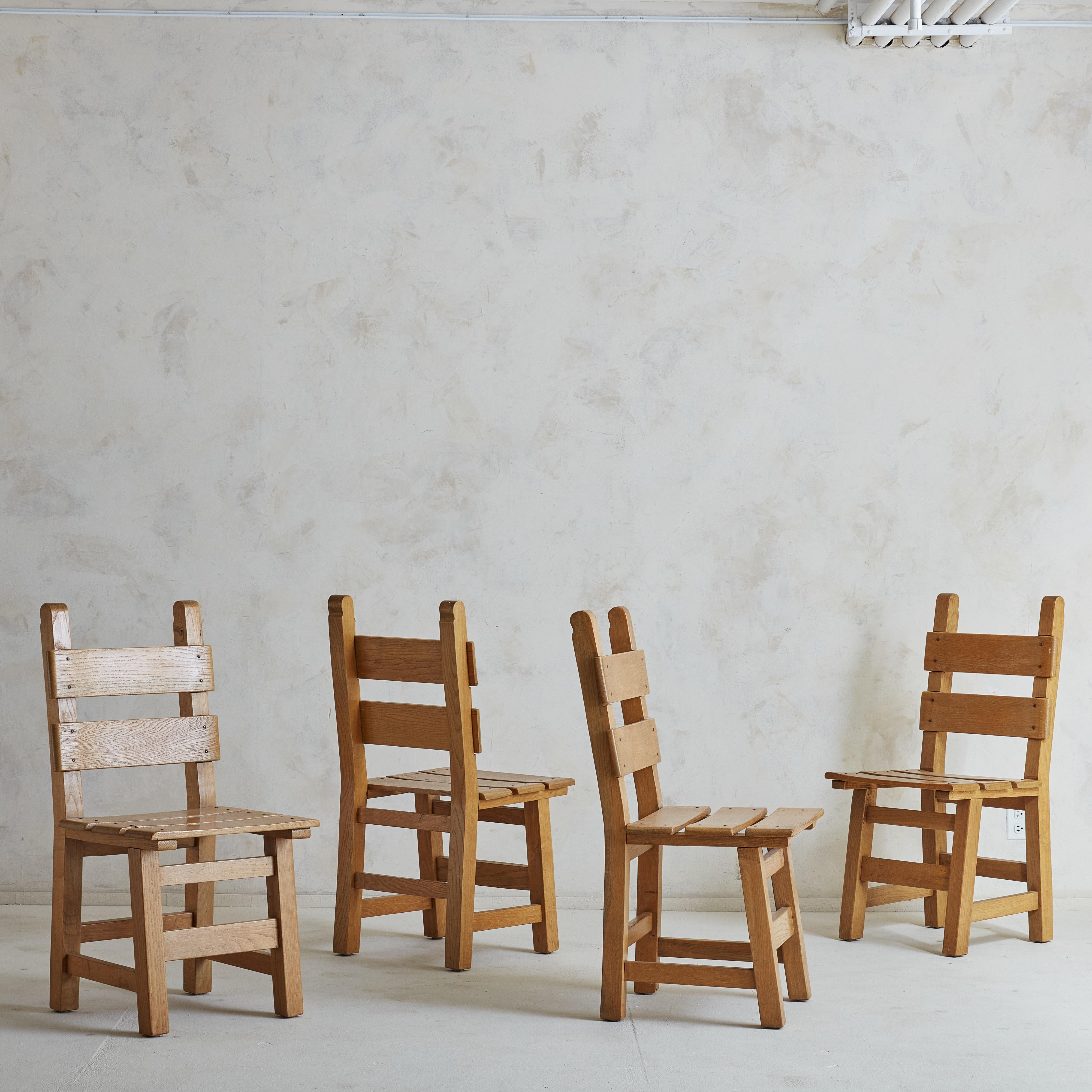 A set of 4 Danish dining chairs constructed of Pine wood. A blend of brutalist inspiration + mountain furniture; we find these to be both ultra functional and charming. The aging on the pine wood brings depth + patina to the set in a way that pair
