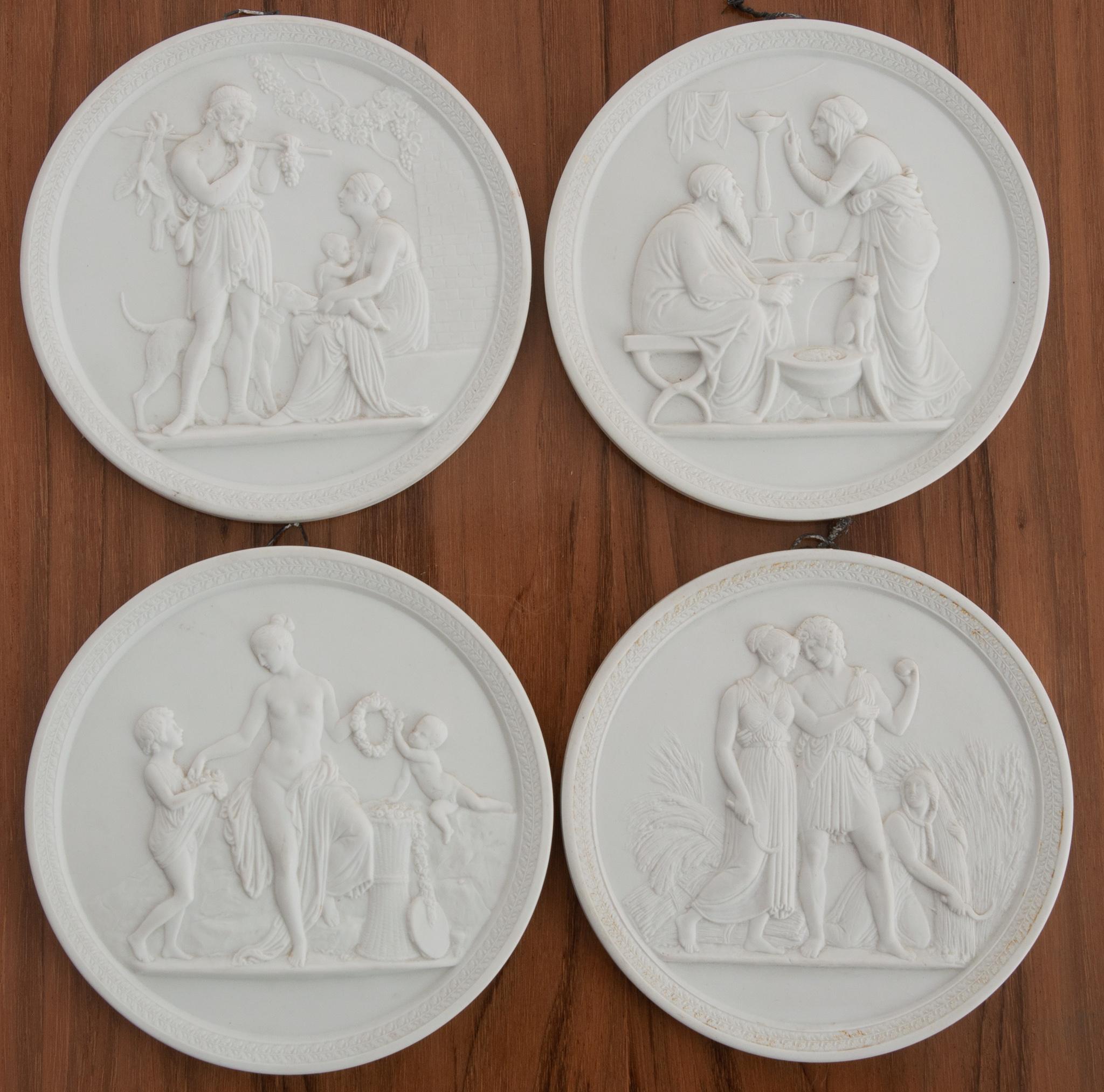 This set of four plaques are made of bisque porcelain by the Danish company, Royal Copenhagen. Stamped with Eneret on the back and has the distinct three blue waves and Royal Copenhagen backstamp. The neo-Classical, low relief designs depict the