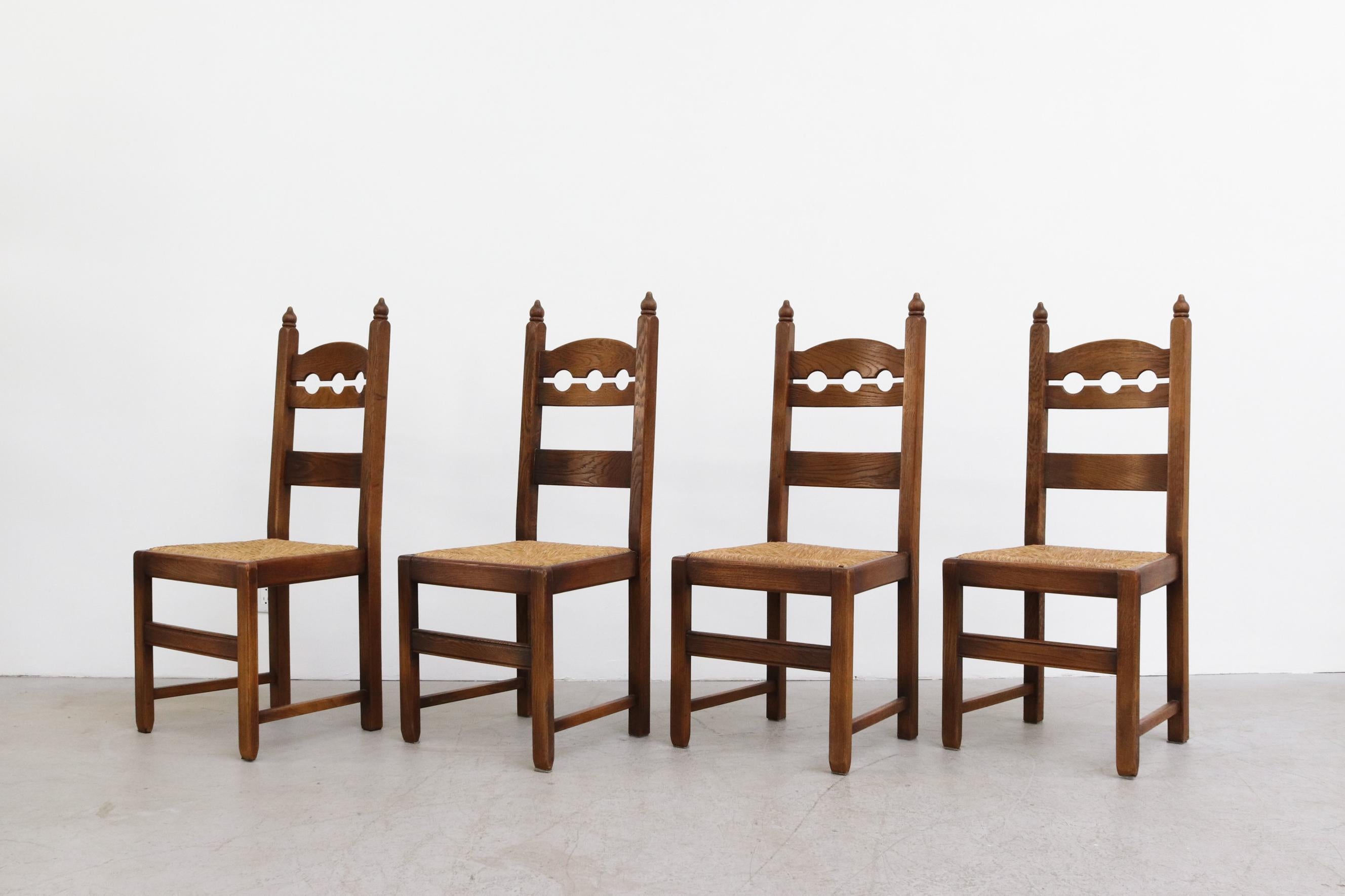 Set of 4 Danish oak razor back dining chairs with rush seat. Lightly refinished with some remaining minimal wear. Rush is in good condition. Wear is consistent with age and use. Set price.