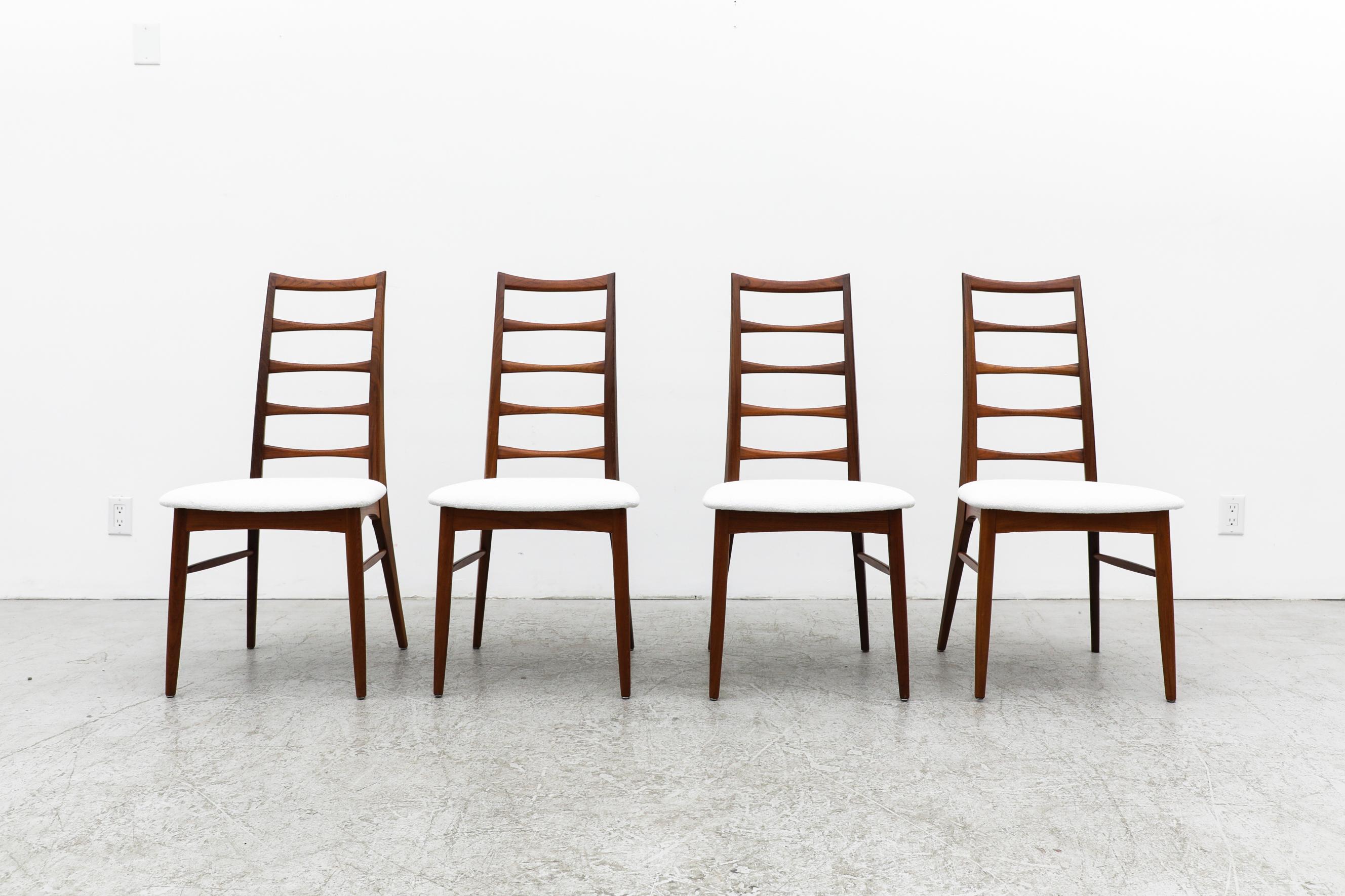 Set of 4 Danish tapered tall ladderback dining chairs with white upholstered seats. In original condition with minimal signs of wear, consistent with their age and use. Other ladderback dining chairs are available and listed separately.