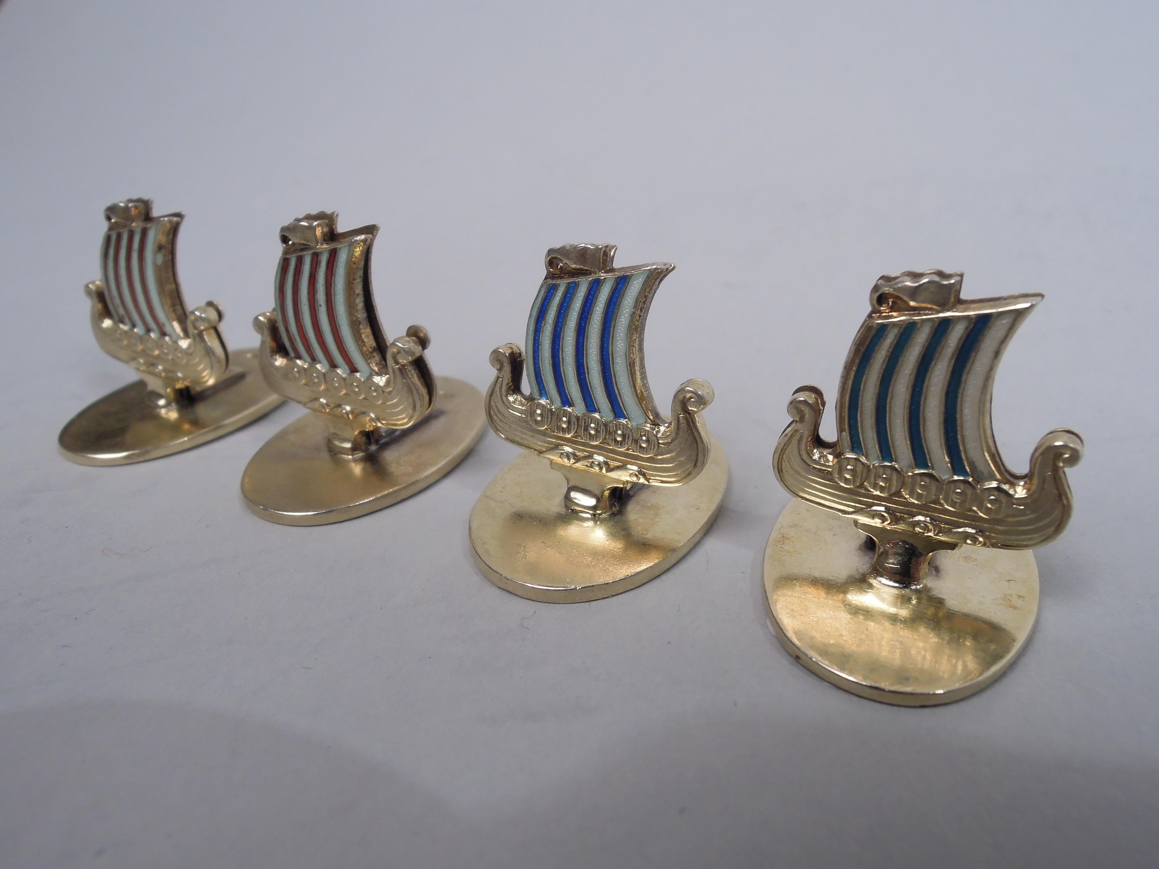 Set of 4 gilt and enameled sterling silver place card holders. Made by David Andersen in Norway, ca 1920. Each: Clip in form of Viking boat with scrolled posts and warrior shield rim. Stealthy movement suggested by billowing sails and lapping water.