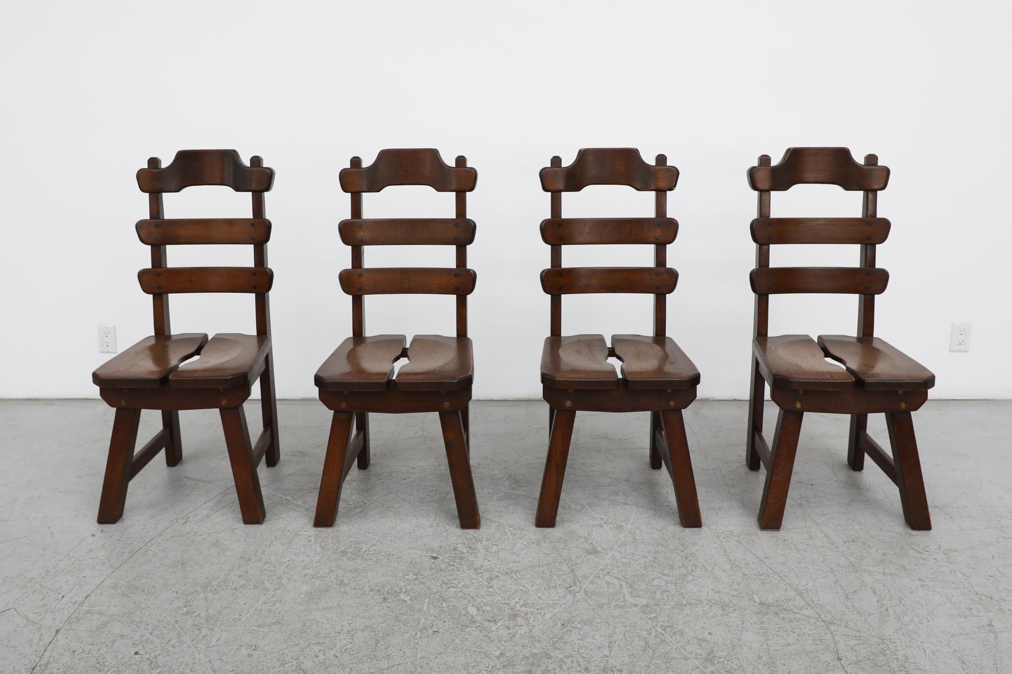 1960's, Belgian set of 4 Brutalist ladder back side or dining chairs. Handsomely made from dark stained solid oak. These chairs have a classic Brutalist design with split seats and wonderful carved details on the backrests and seats. Lightly