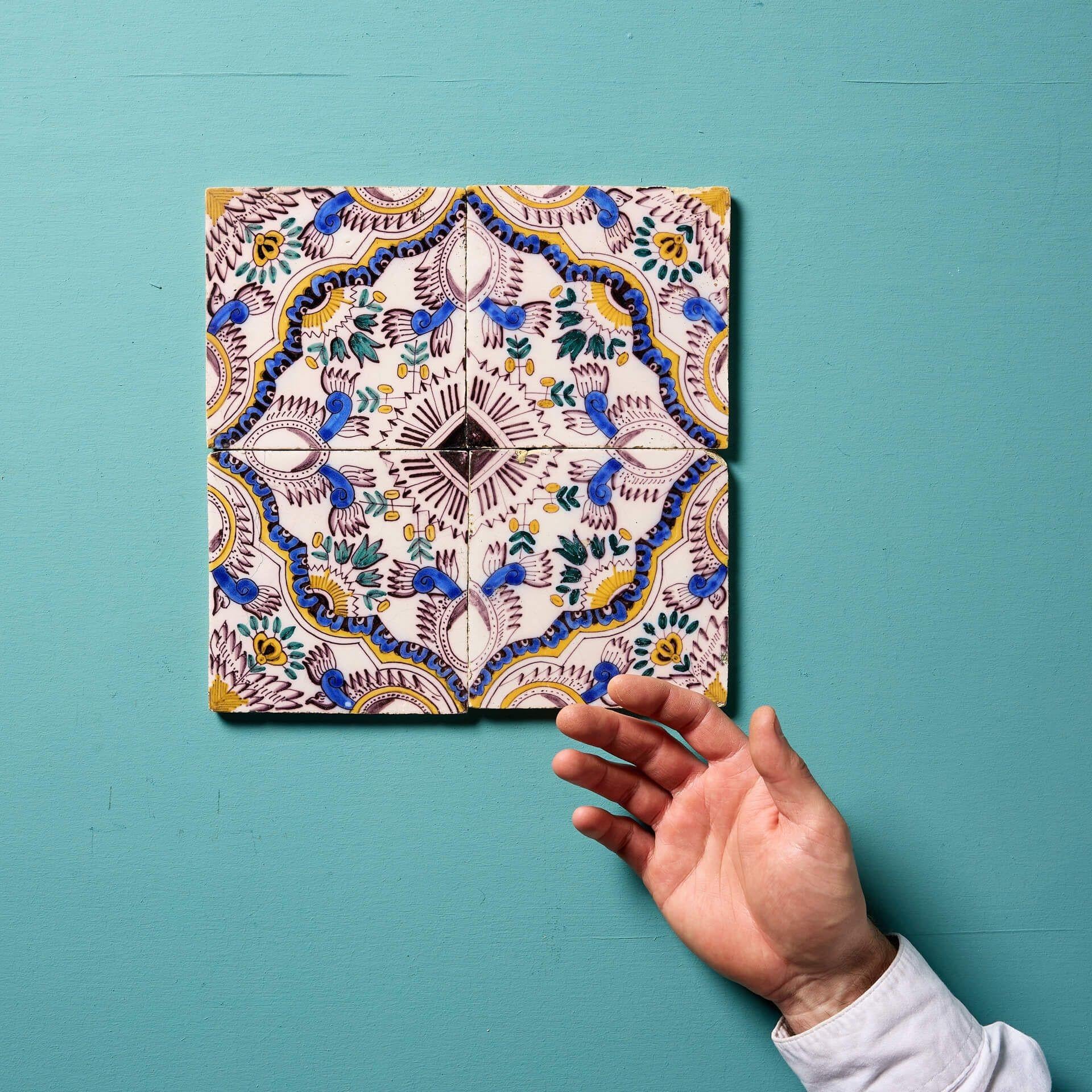 A set of 4 Delft patterned polychrome wall tiles known as English chintz.

Dating to circa 1850, each 5 inch tile showcases classically hand decorated floral patterns in a vibrant blue, yellow, and ochre.

We have 2 other sets of tiles available in