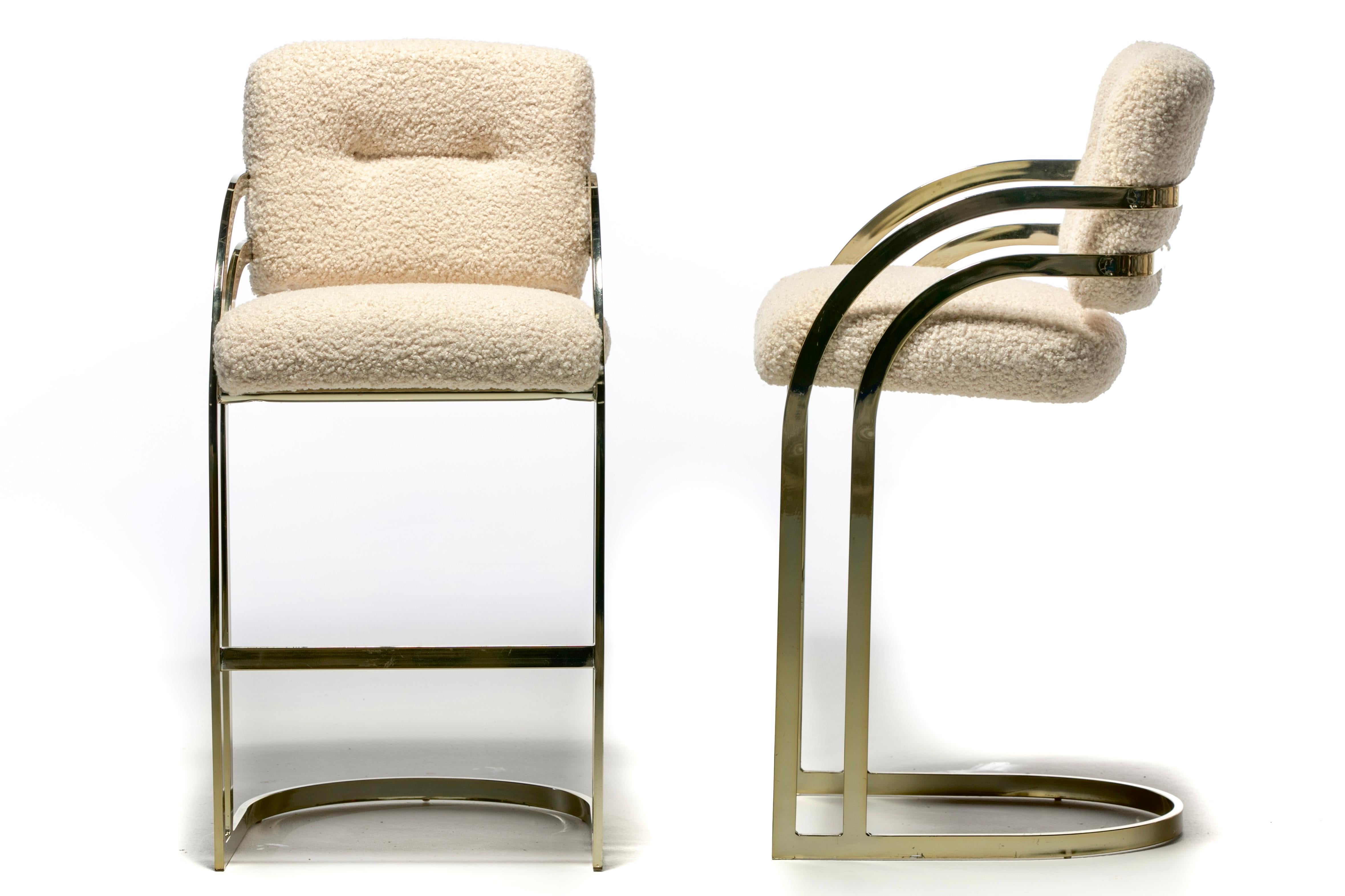Elegant and luxurious set of four cantilevered brass stools in the style of Milo Baughman made by Design Institute of America (