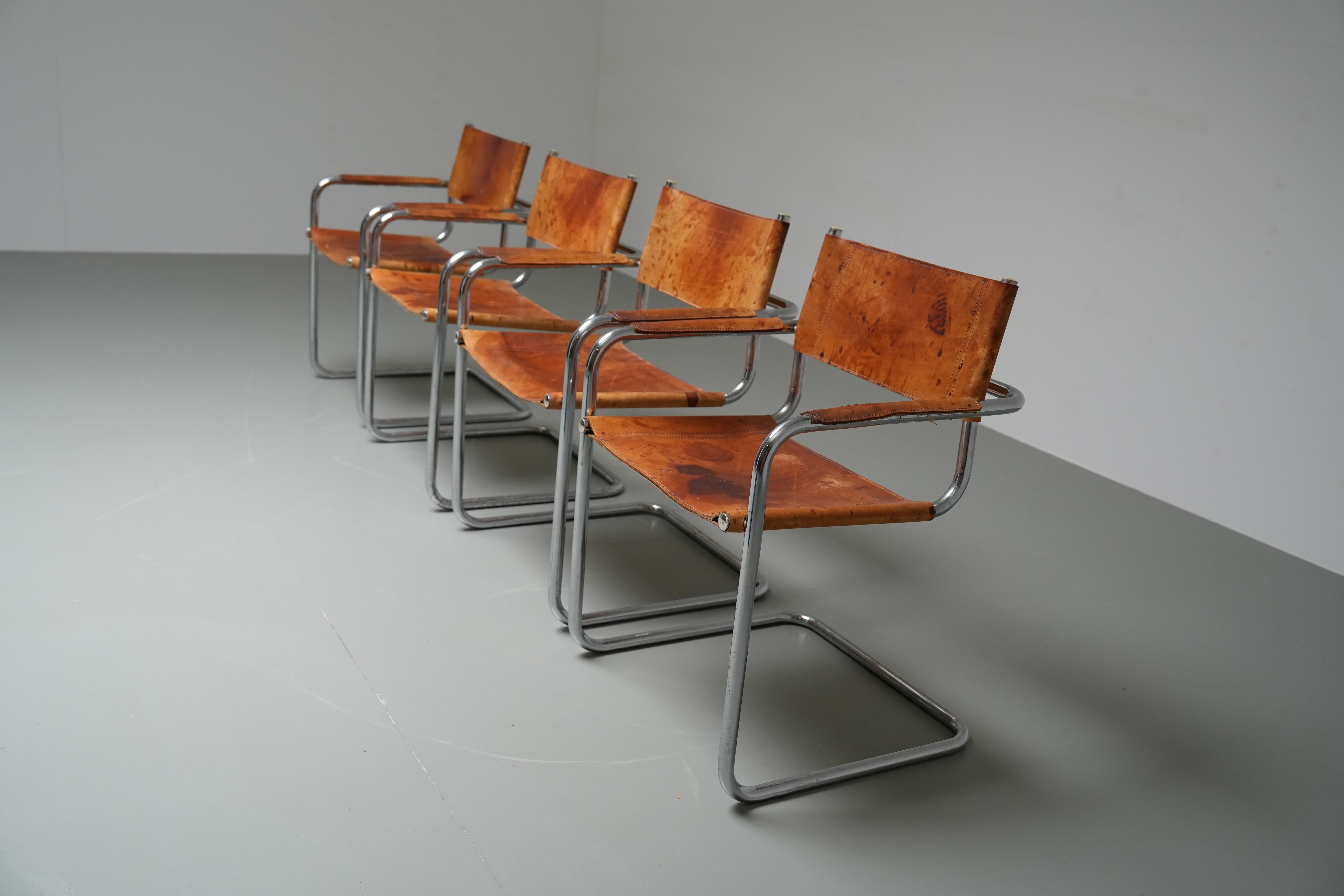 Beautiful set of 4 Dining Room chairs B34 by Mart Stam and Marcel Breuer. The cognac leather is really patinated as you can see on the photos and we love it  a lot. Great set if you want some character in your house.