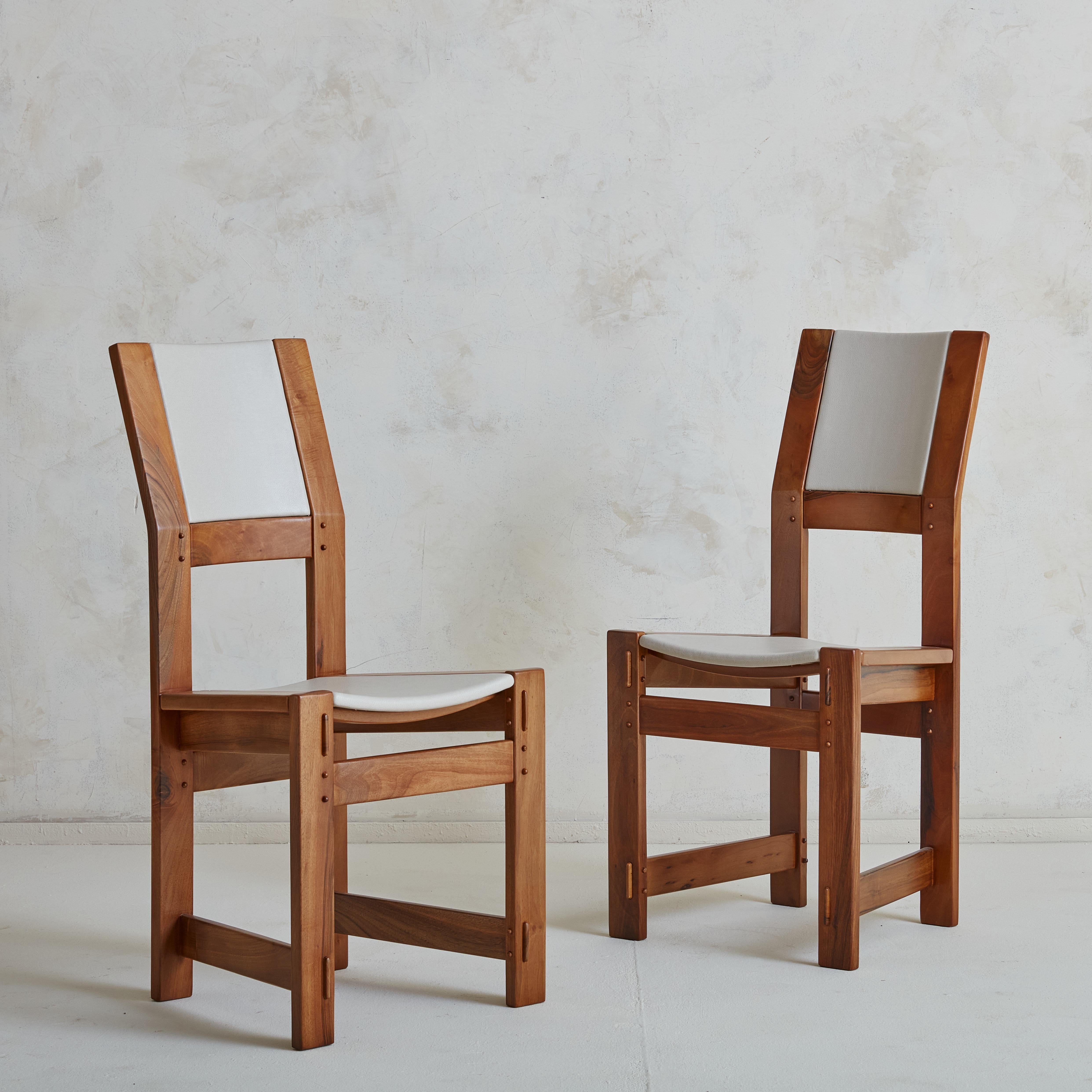 A gorgeous set of 4 dining chairs by sculptor and designer Giuseppe Rivadossi for Officina Rivadossi. The sculptural yet minimal oak frame is slightly tiled, creating a very functional and comfortable seating position. We have restored these in a