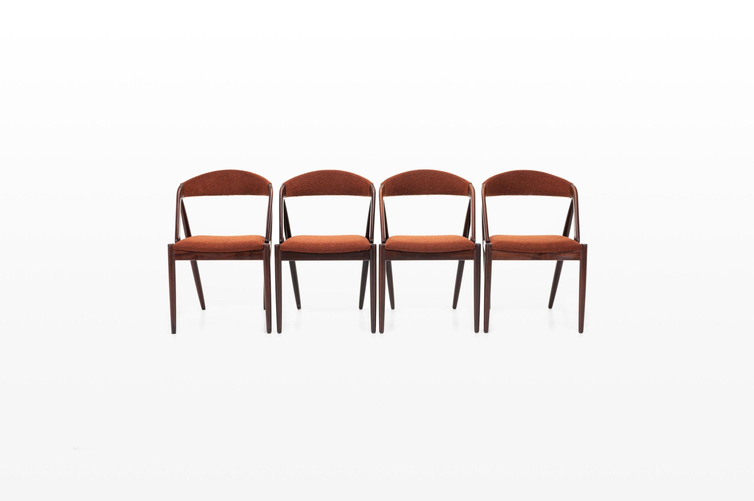Very nice set of four vintage chairs designed by Kai Kristiansen for Schou Andersen Møbelfabrik in the 60s. The chairs have been reupholstered with a bordeaux boucle fabric.
 