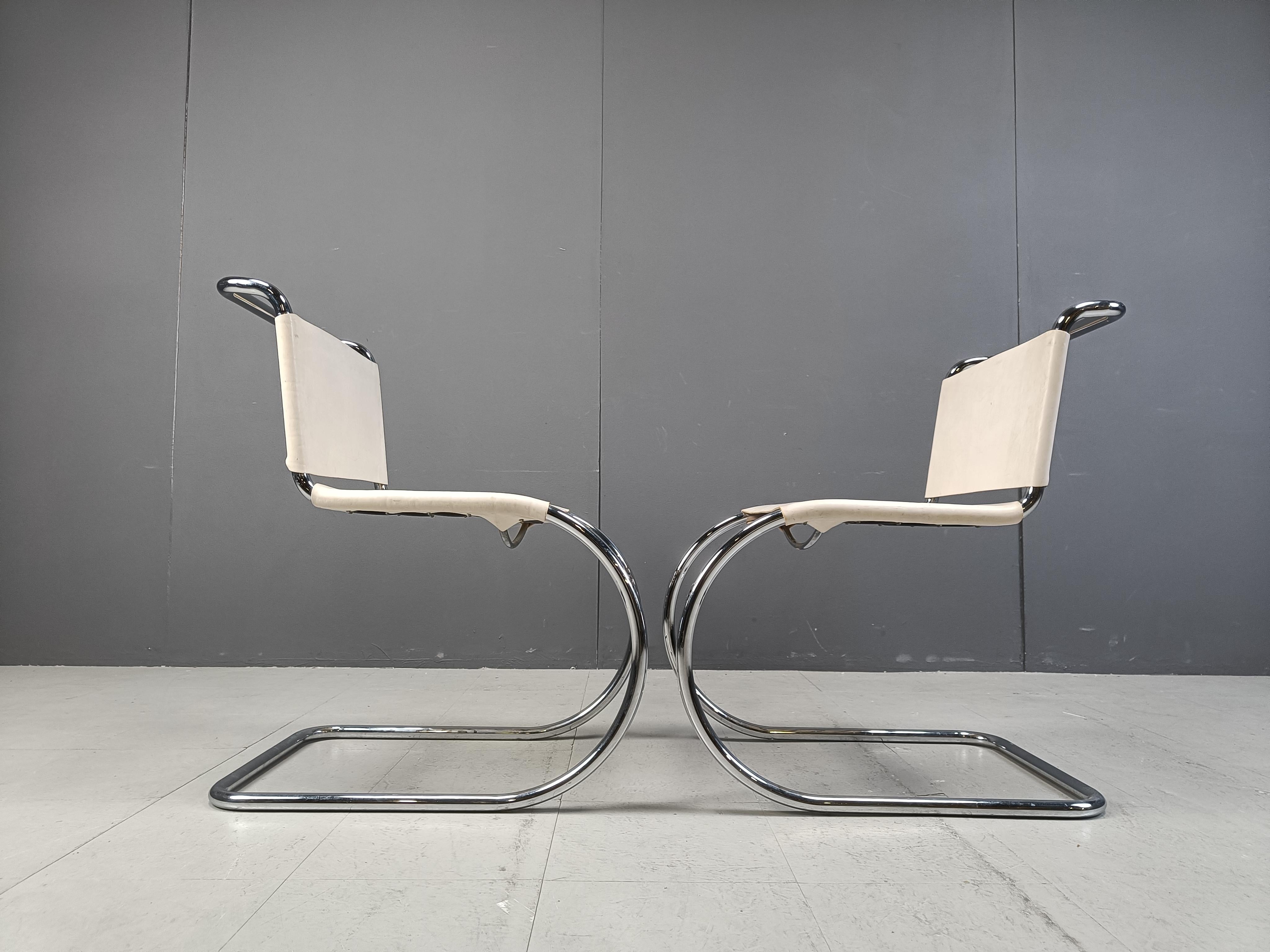 Vintage  cantilever dining chairs or armchairs designed by Ludwig Mies van der Rohe.

Beautiful elegant Bauhaus design with a chromed metal tubular frame and thick quality cream/white sling leather seats and backrests.

Timeless design pieces.

Very
